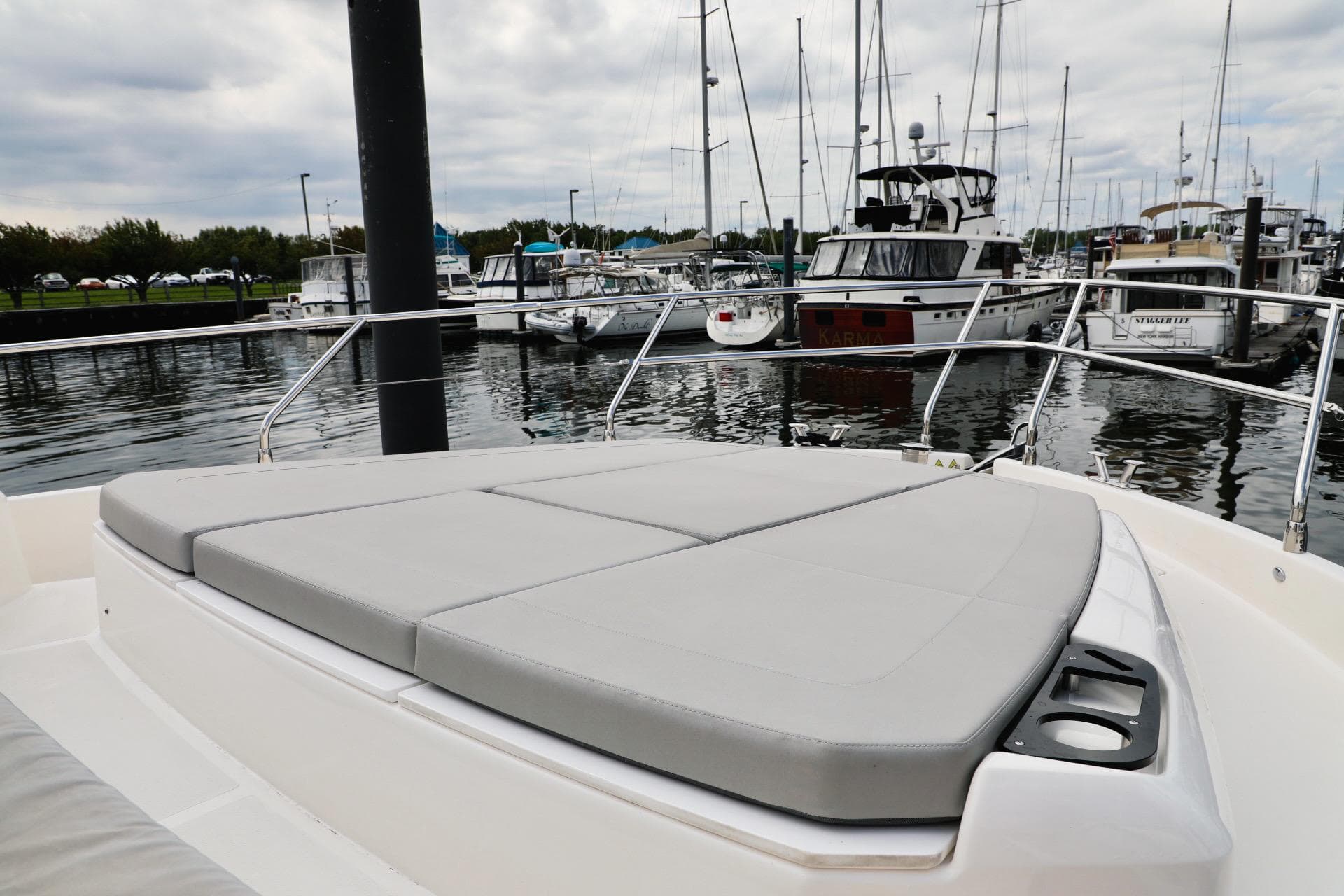 2019 Absolute 50 Fly yacht with cushioned deck at marina.