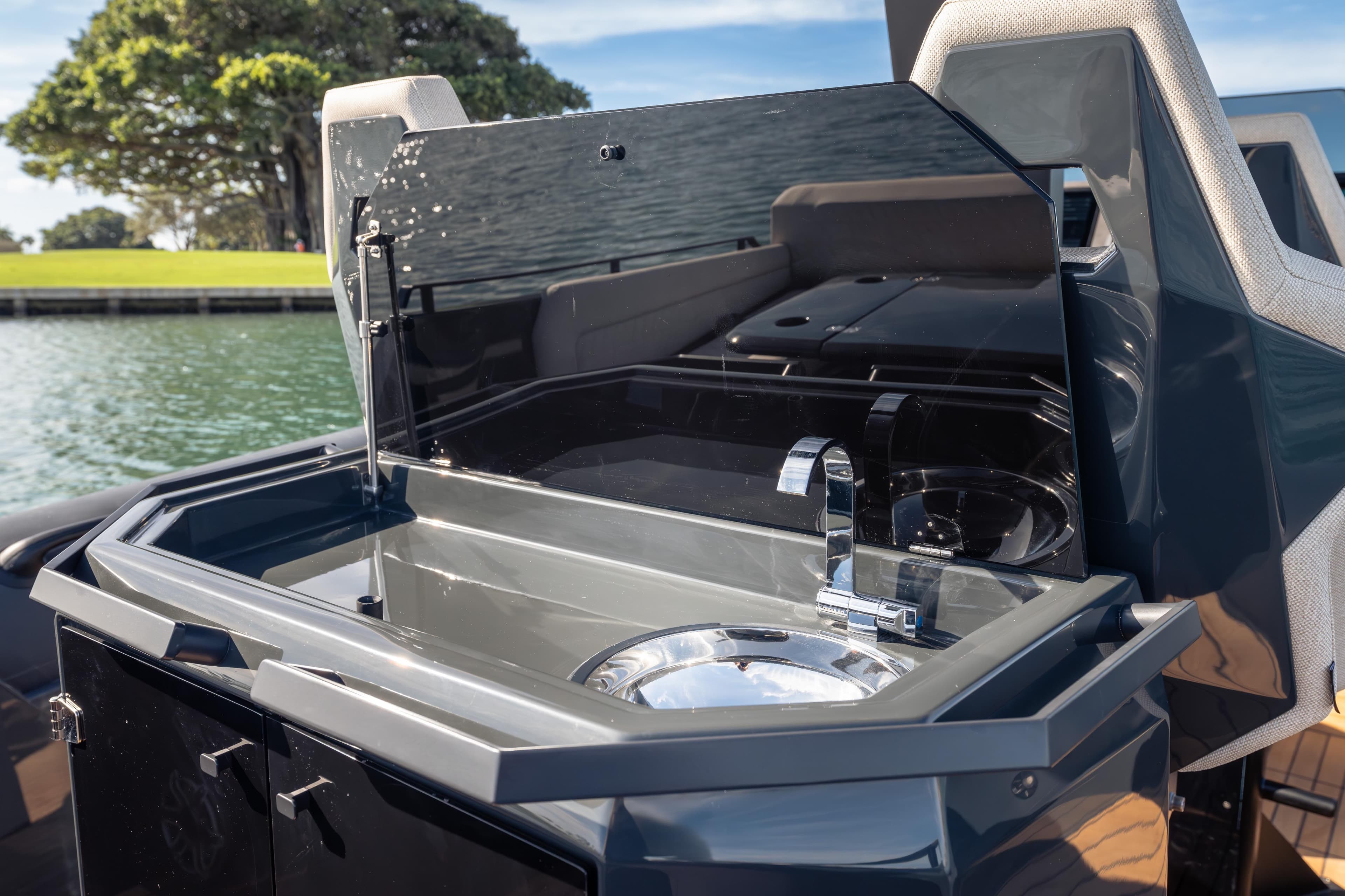 Outdoor kitchenette on 2024 Skipper-BSK 38NC boat with sink and faucet.