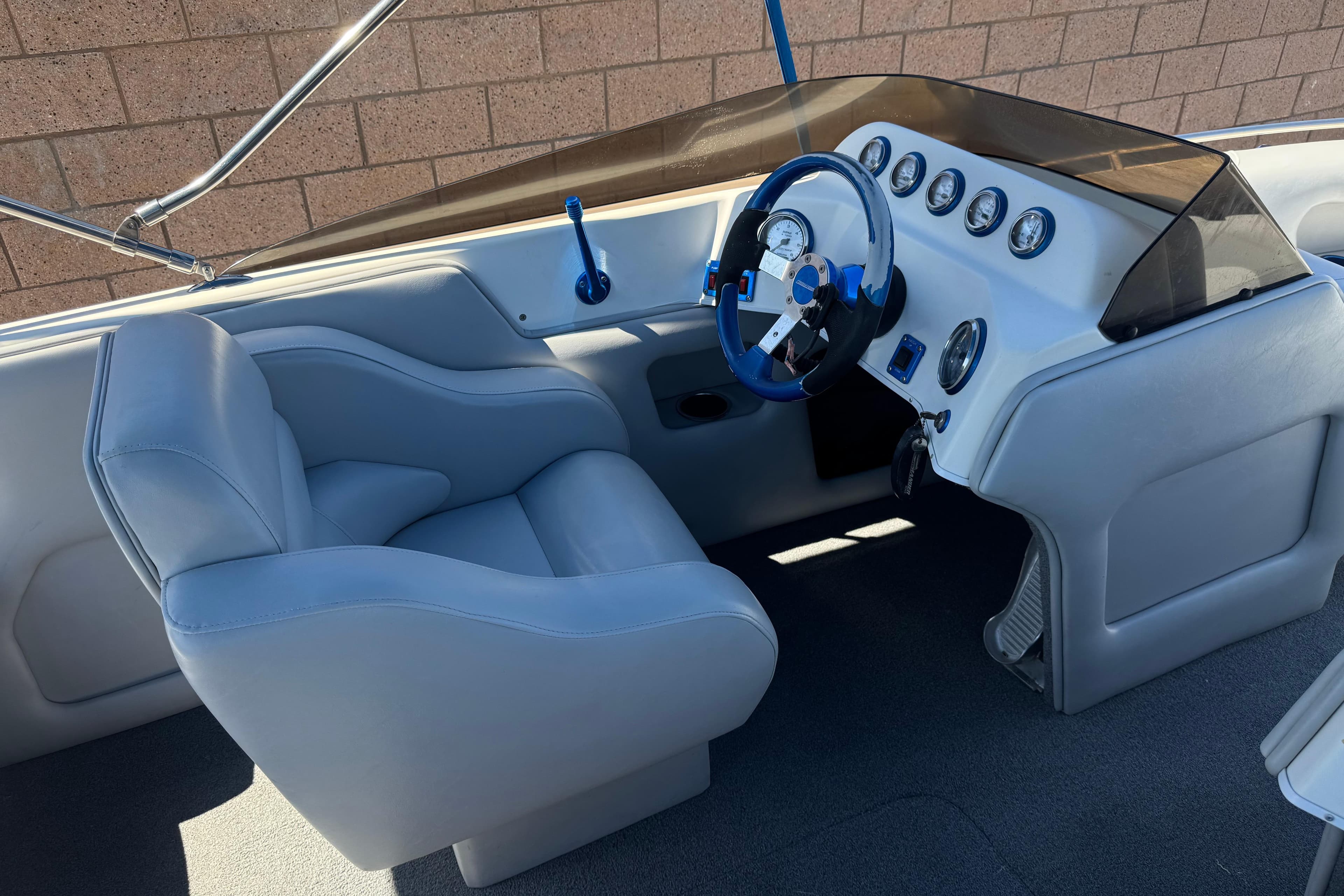 Interior of a 2007 Commander 2300LX boat with sleek dashboard and comfortable seating.