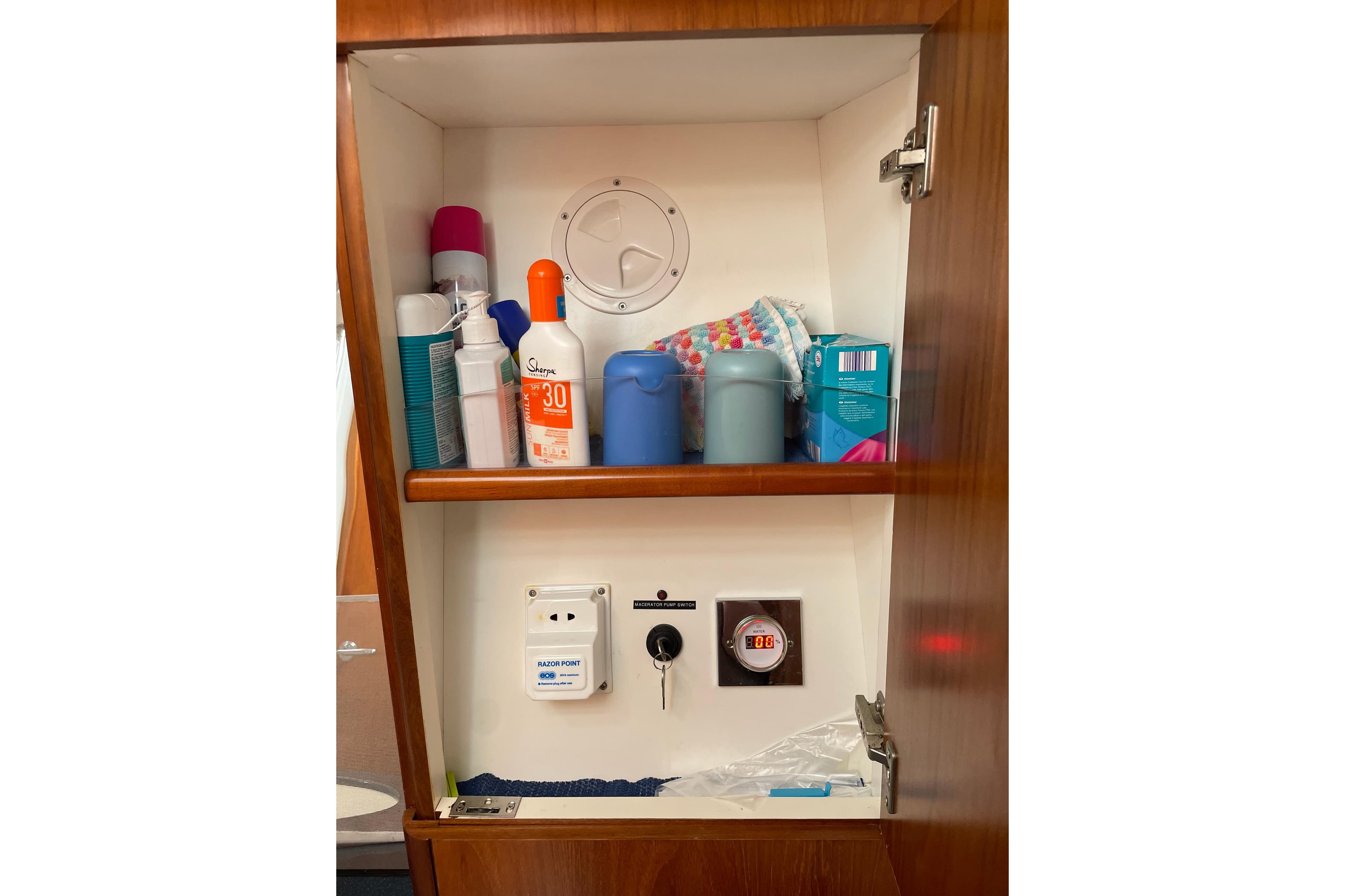 Cabinet with toiletries and electrical outlets on a 2004 Moody 56 yacht.