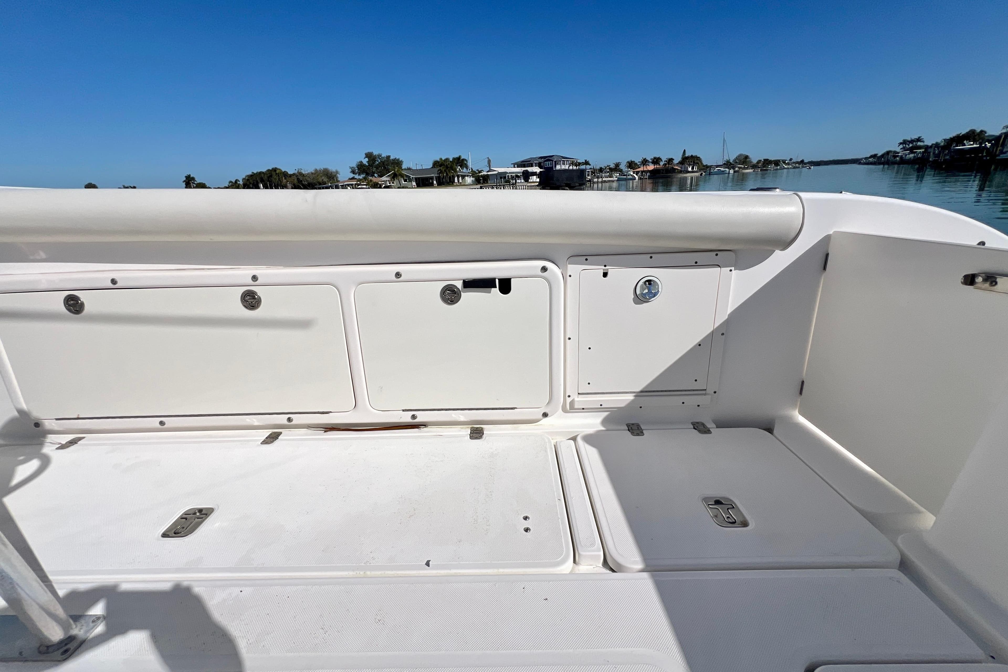 2005 Century 3200 Center Console boat interior with storage compartments, docked on a sunny day.