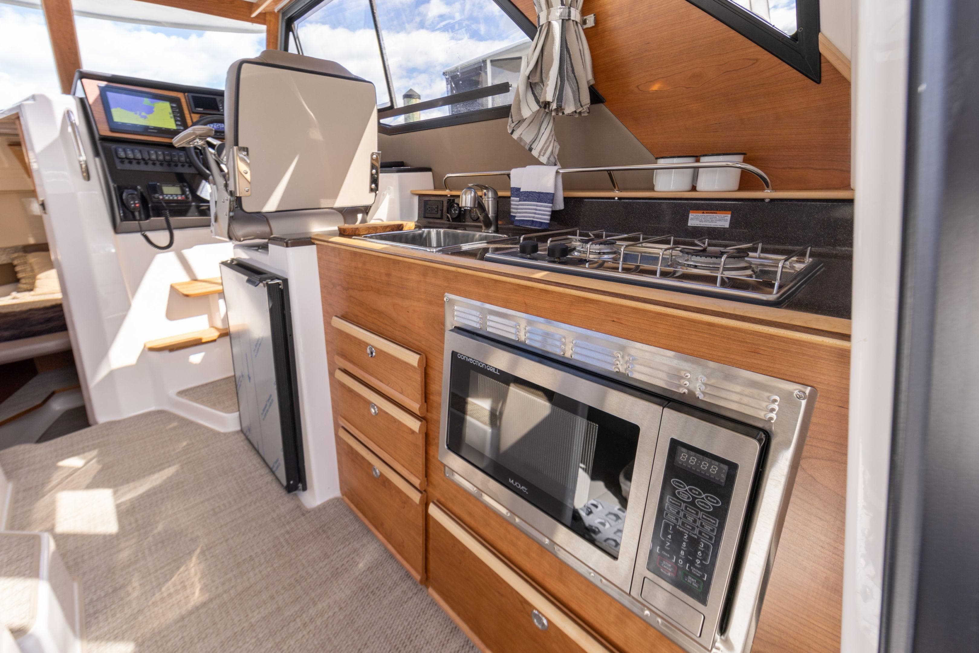 2026 Cutwater C-288 Coupe interior with modern kitchen and navigation controls.