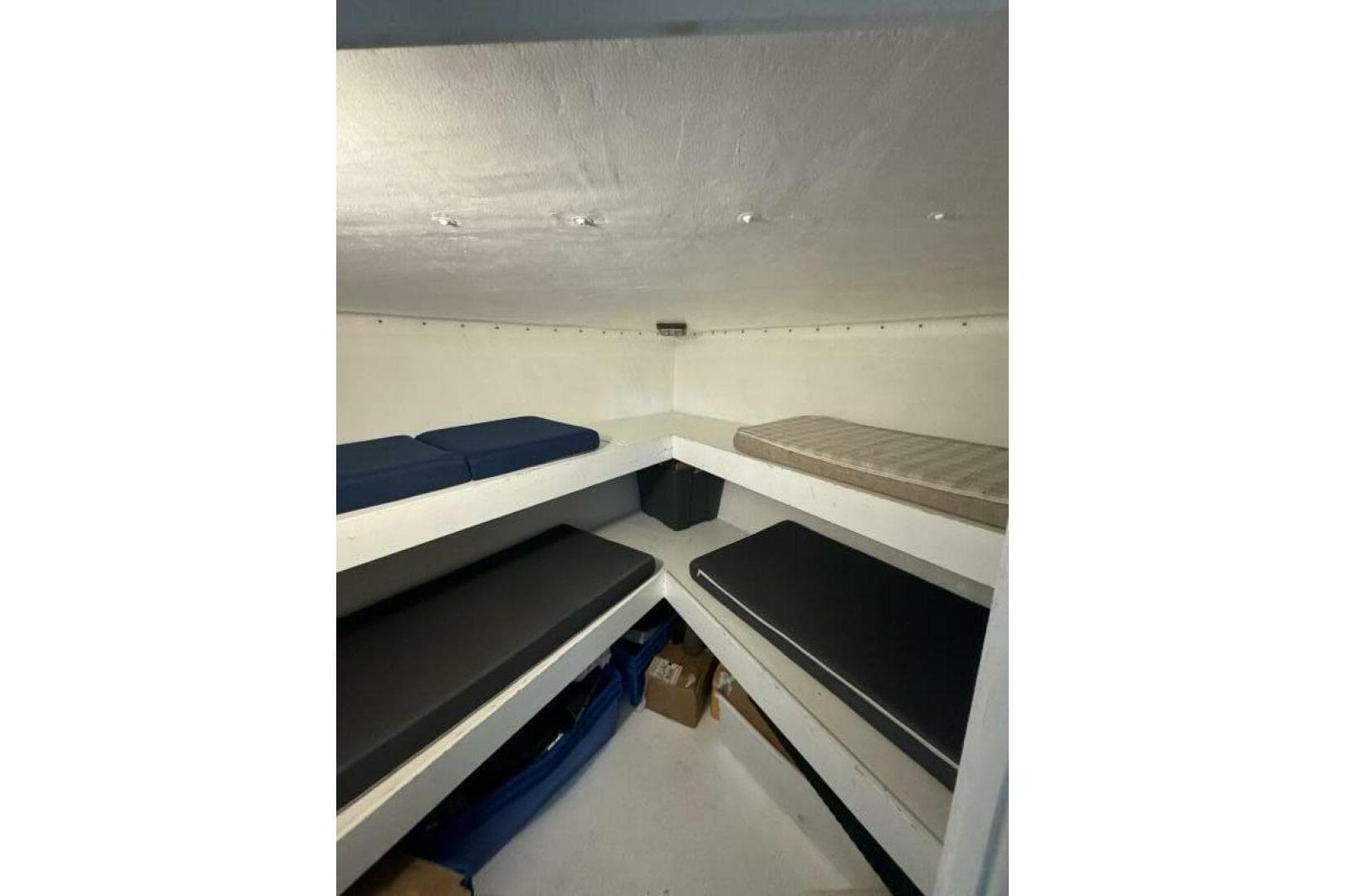 Interior cabin of 1987 Monroe Custom 52 with multiple cushioned bunks.