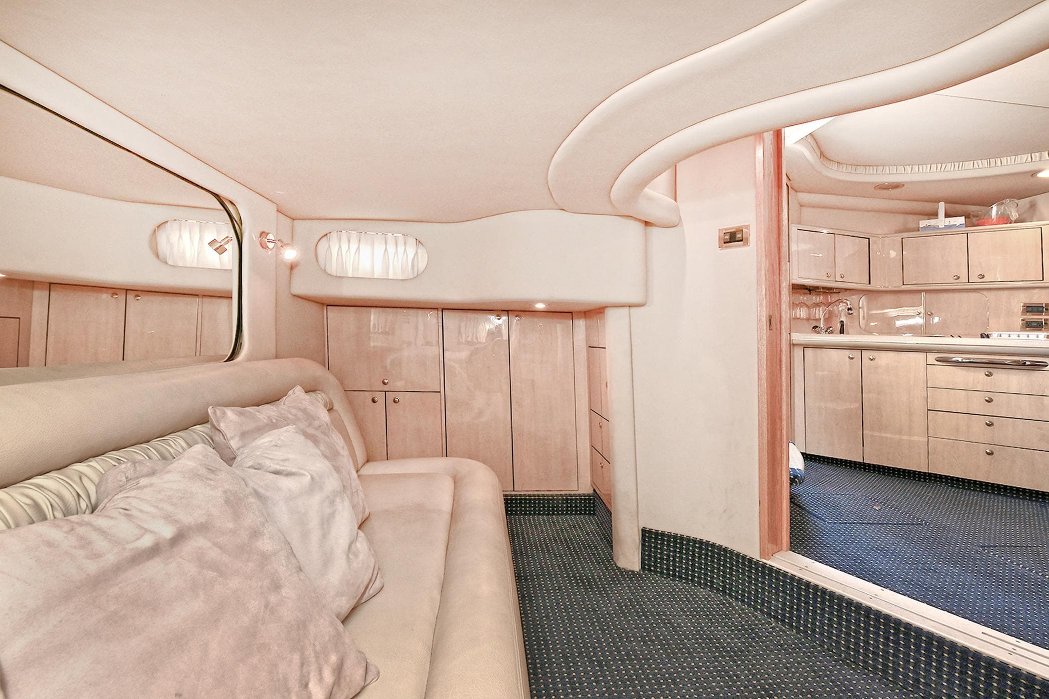 Luxurious interior of 2000 Sea Ray 460 Sundancer yacht with plush seating and modern kitchen.