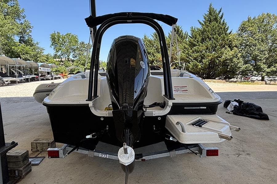 2026 Bayliner Element E18 boat on trailer, rear view with outboard motor.
