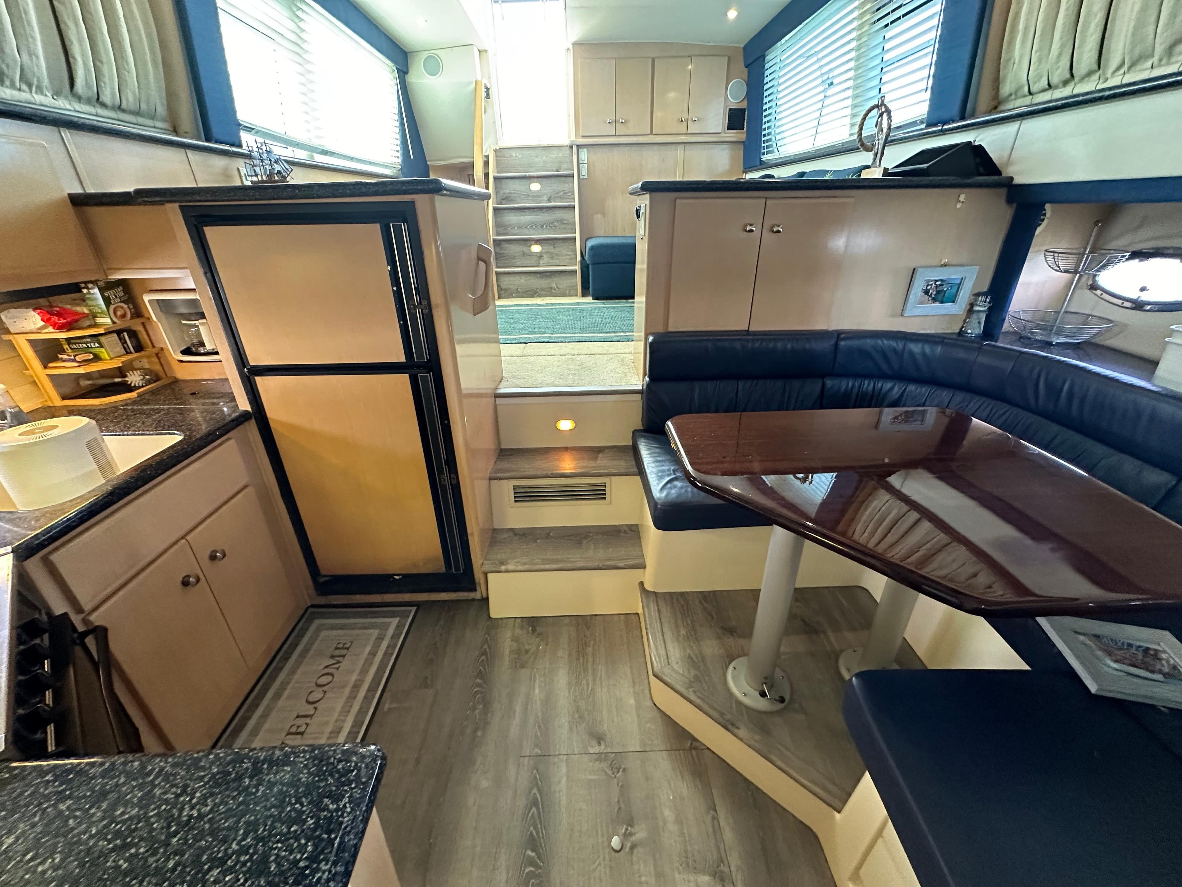 Interior of a 2000 Carver 406 Motor Yacht with kitchen and dining area.