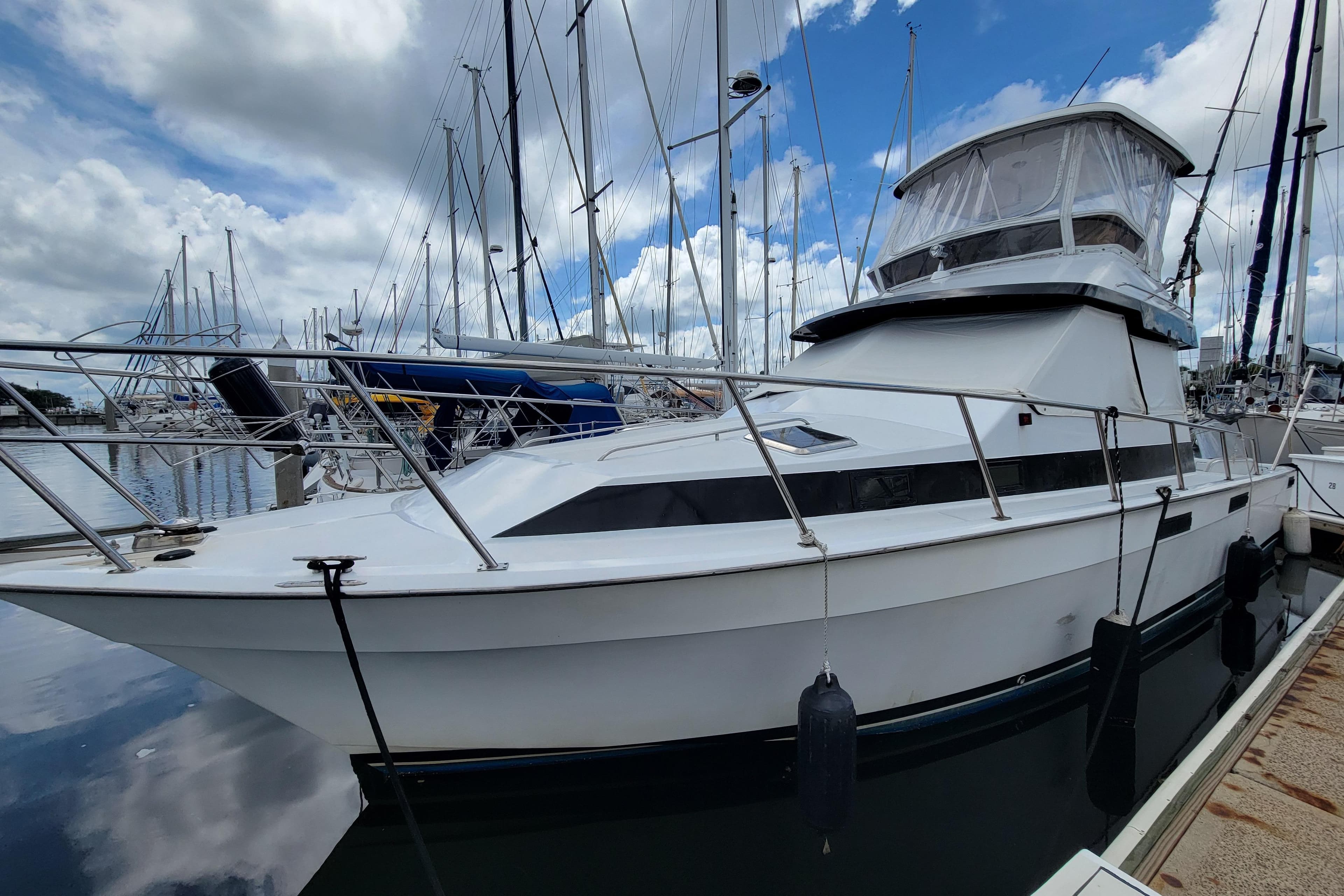 1992 Mediterranean 38 yacht docked at marina under cloudy sky.