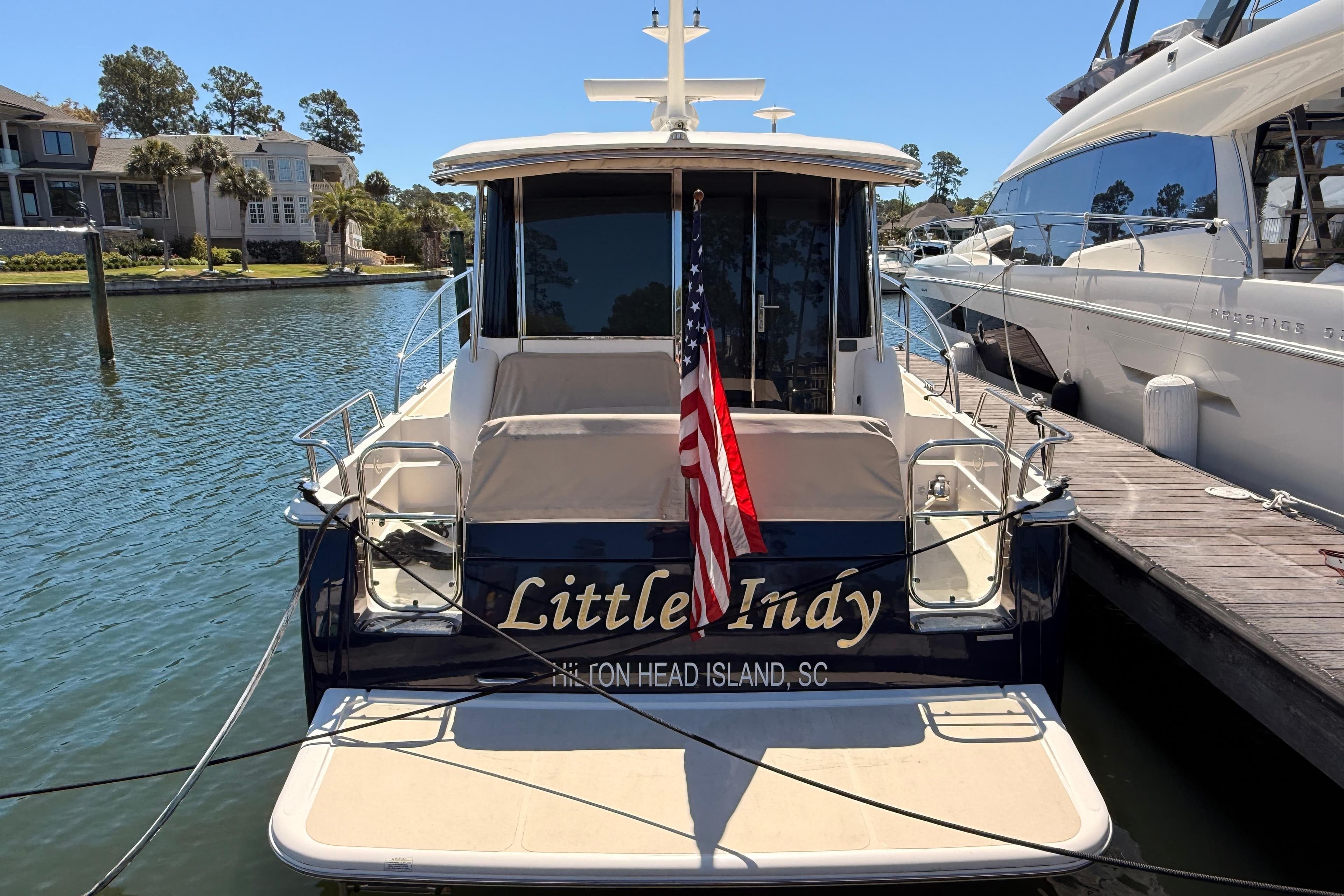 2022 Sabre 38 Salon Express docked, featuring "Little Indy" name and American flag.