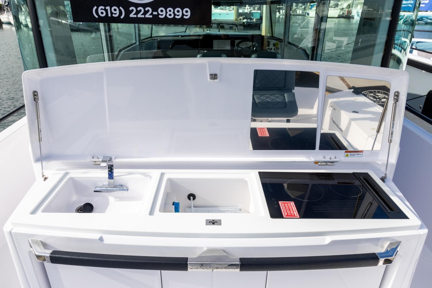 2023 Axopar 37 XC Cross Cabin BRABUS Trim wet bar with sink and stove.