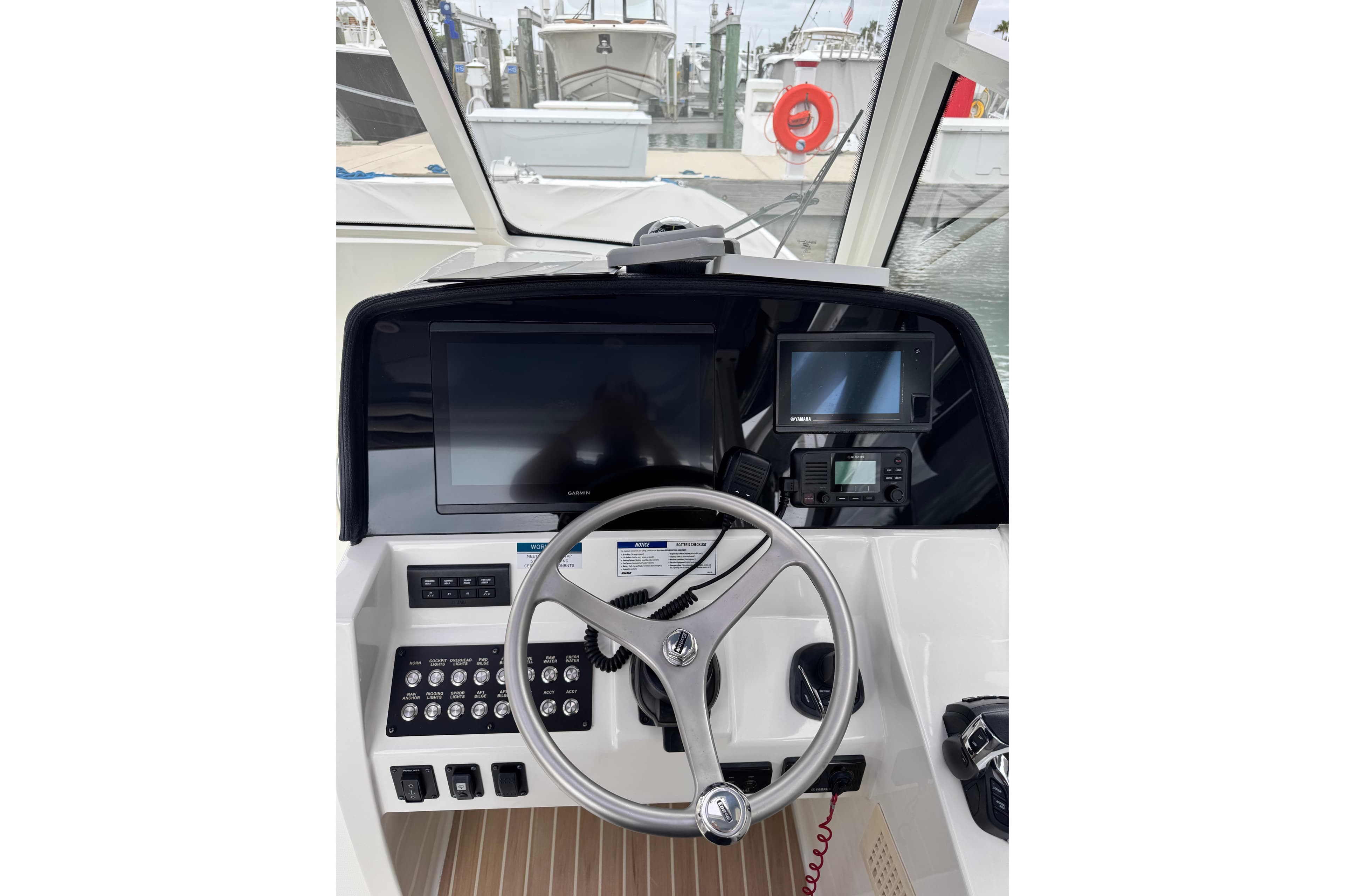 Helm of 2022 World Cat 325 DC boat with modern navigation equipment and steering wheel.