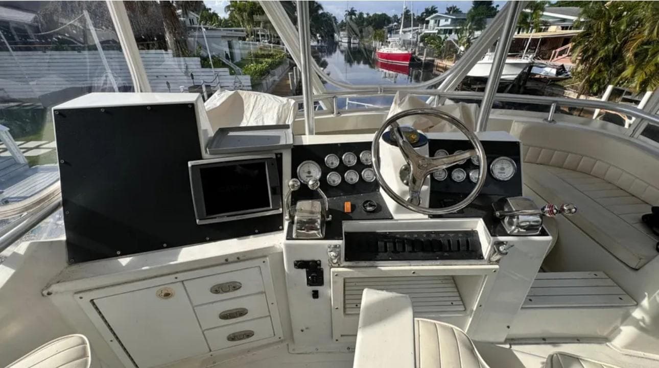 1987 Blackfin Convertible boat cockpit with steering wheel, gauges, and navigation equipment.