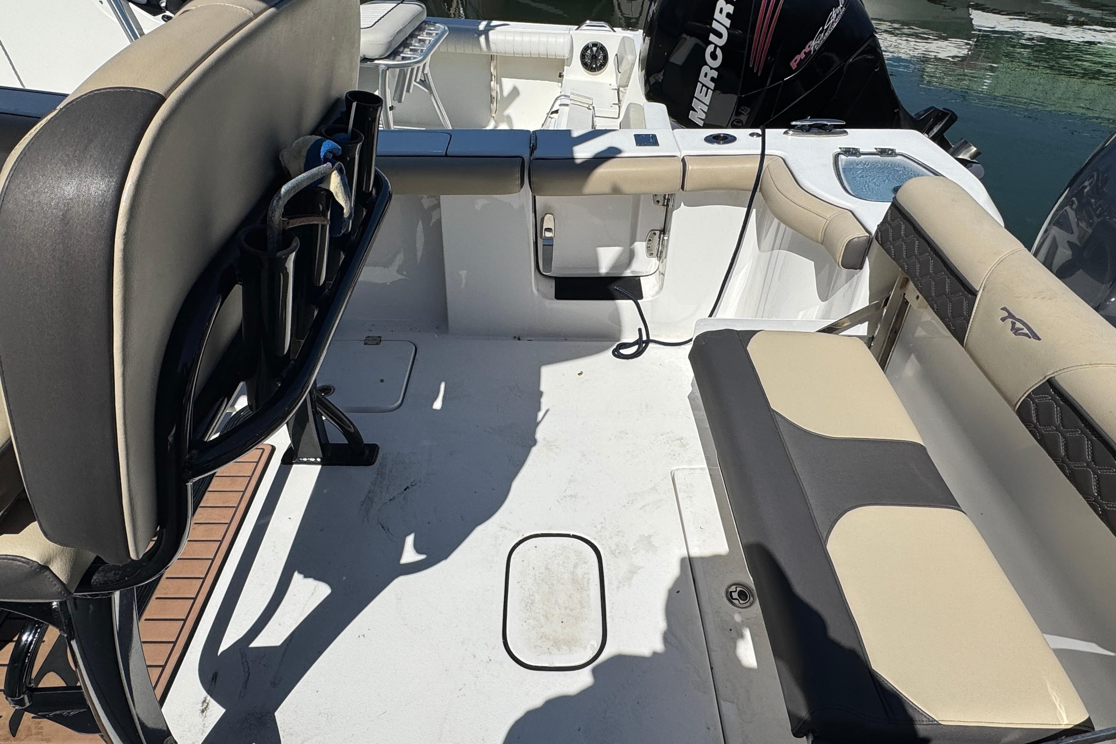 2022 Tidewater 256 CC Adventure boat interior with seating and Mercury engine.