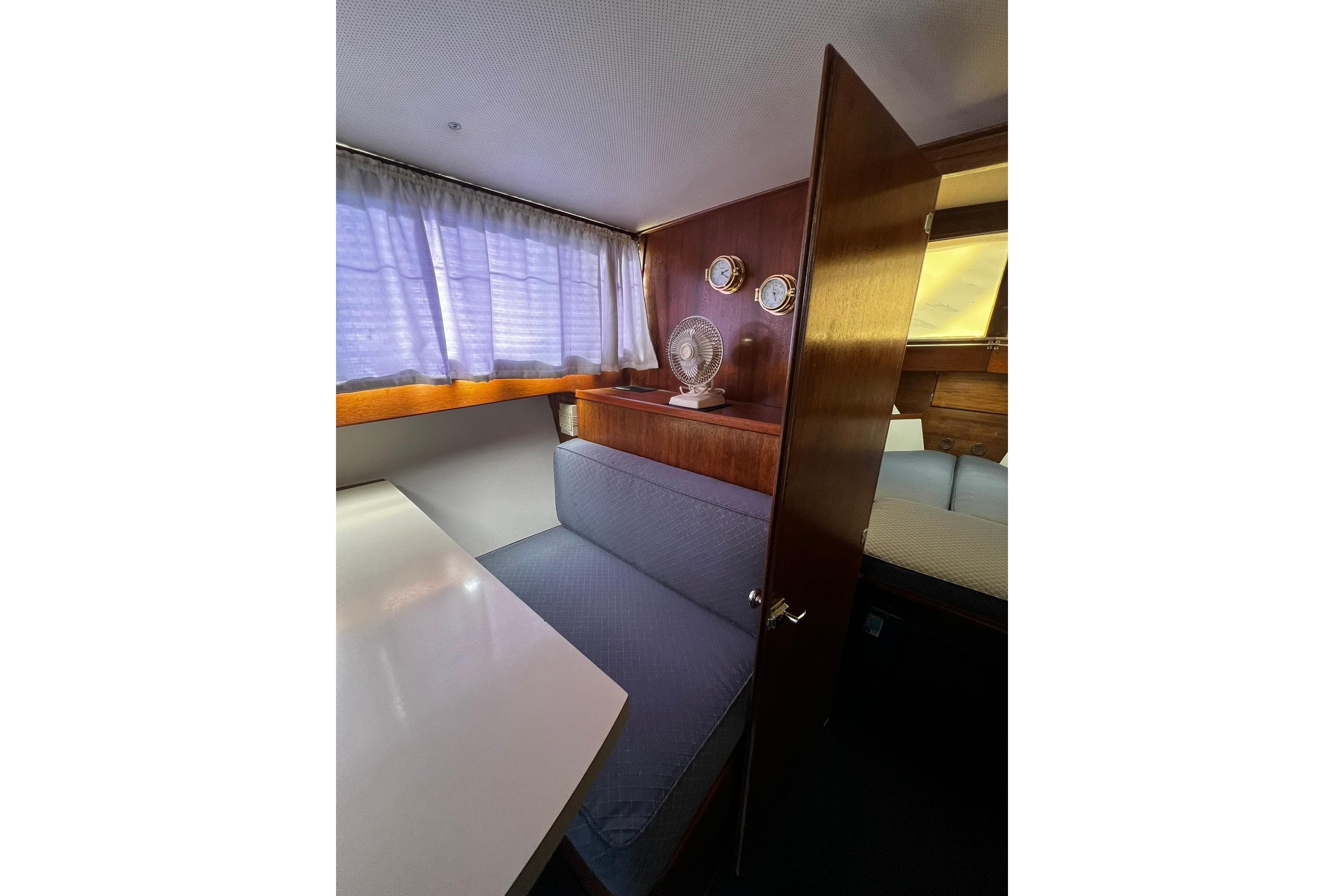 1967 Chris-Craft 31 Commander interior with wood paneling, seating, and nautical decor.