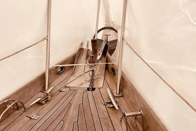 Deck view of 1993 Brooklin Boat Yard Marshall 48, featuring wooden planks and metal fittings.