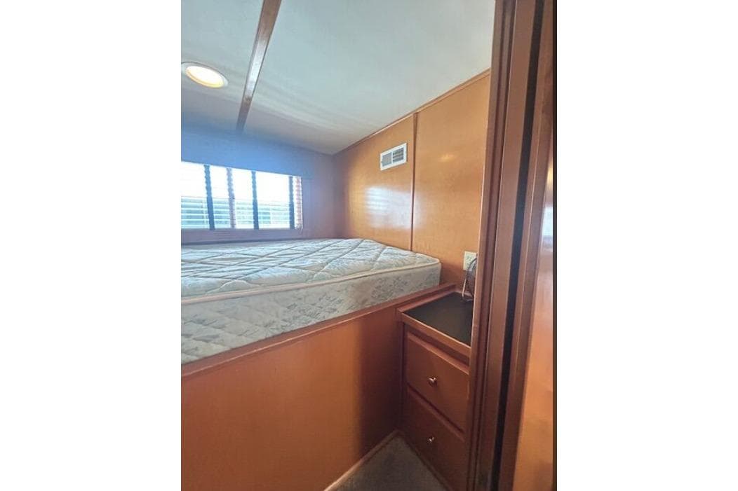2007 Sumerset Lakeview HD bedroom with mattress, wooden walls, and storage drawers.