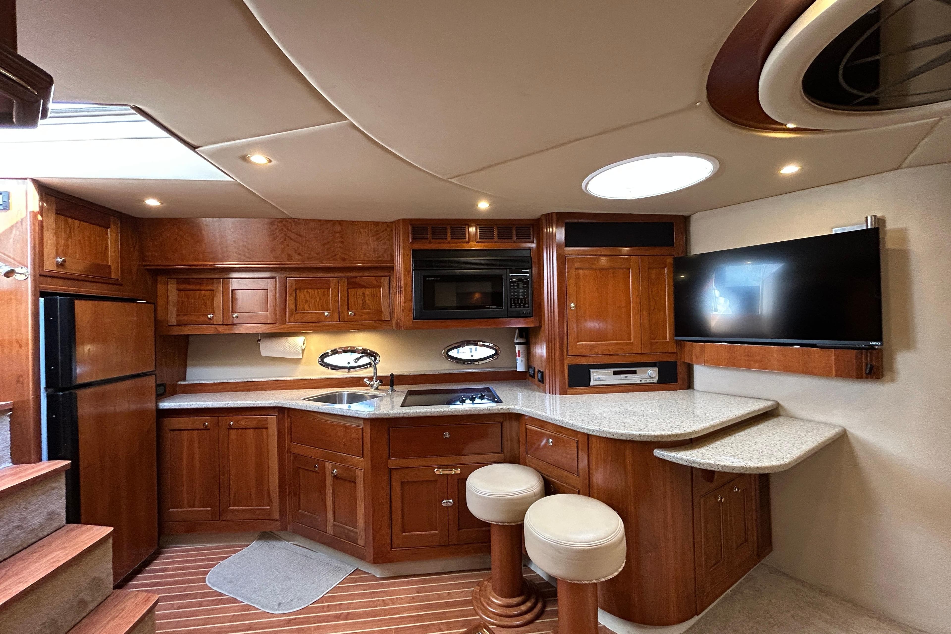 Luxurious 2003 Cruisers Yachts 540 Express interior with modern kitchen and entertainment area.