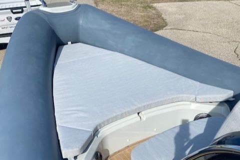 2022 SACS Strider 900 boat with cushioned seating area.