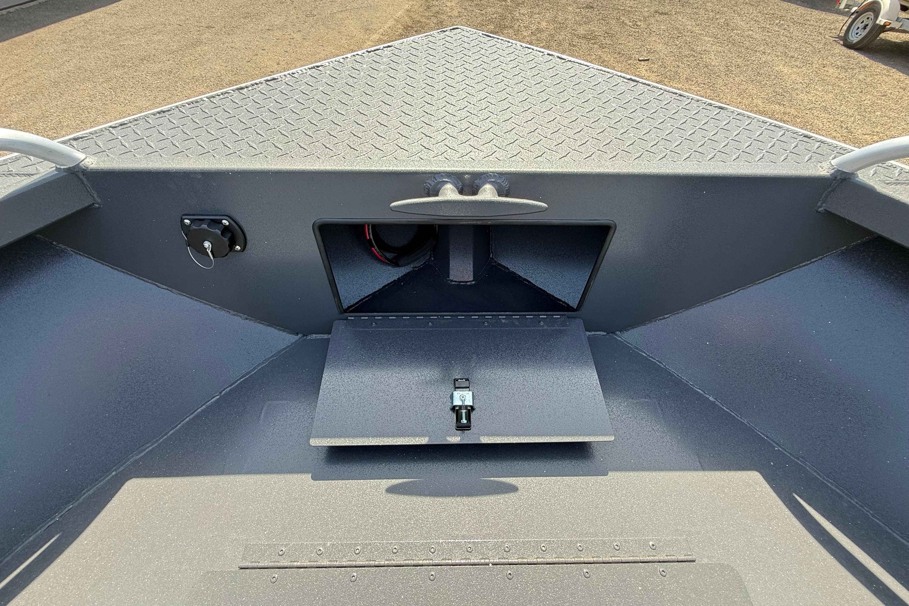 2026 Alumaweld Intruder 22 boat interior with storage compartment and diamond plate flooring.