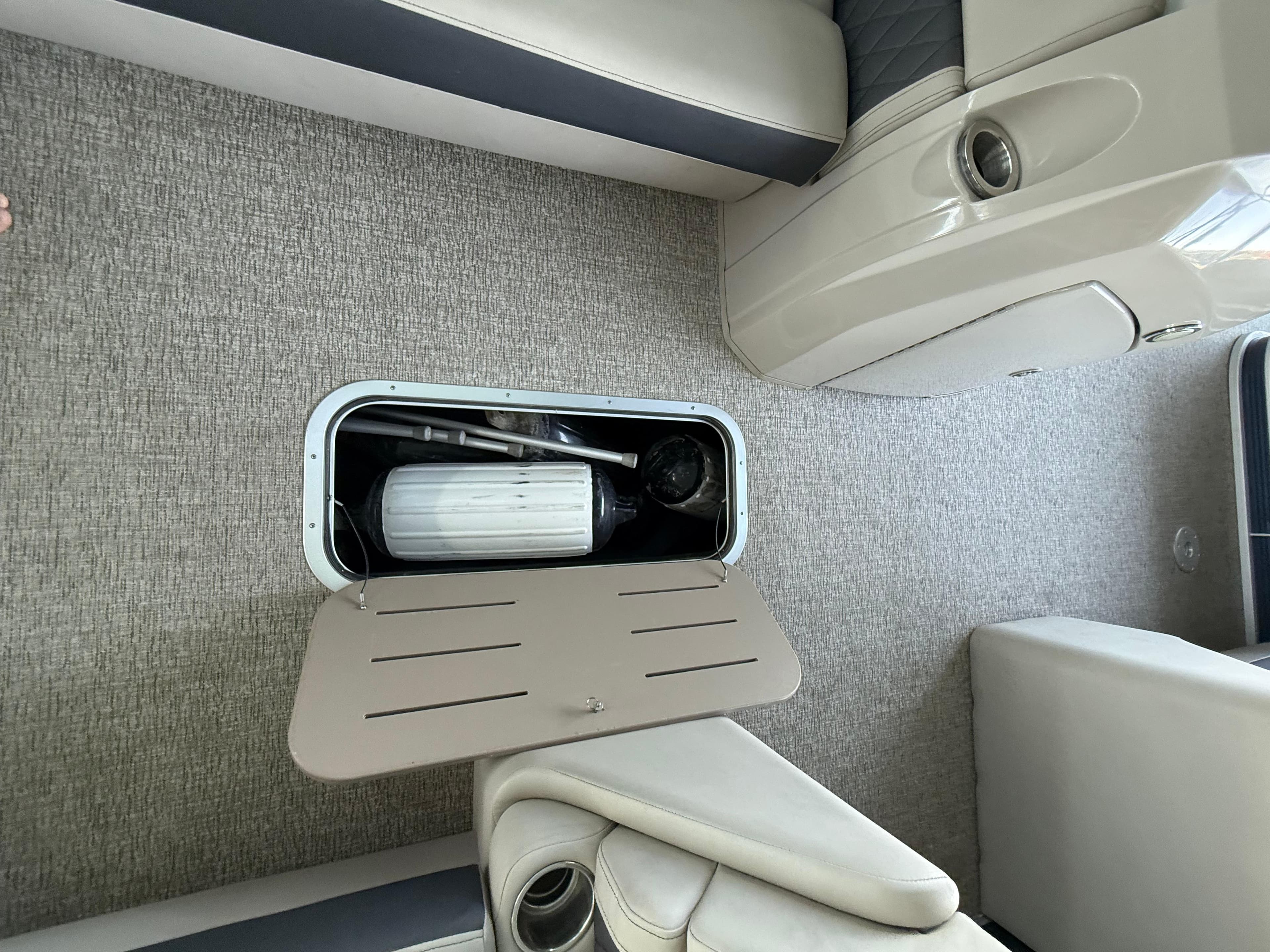 Storage compartment in 2019 Bennington SX 25 Premium Swingback boat interior.