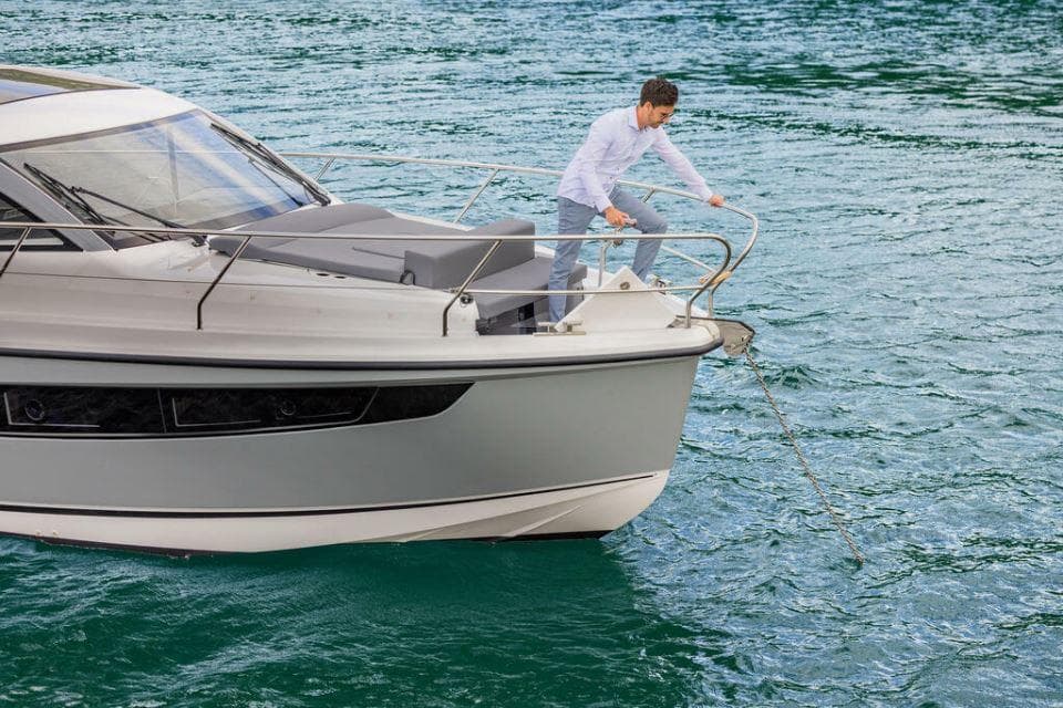 2025 Sealine C335V yacht on water with person handling anchor.