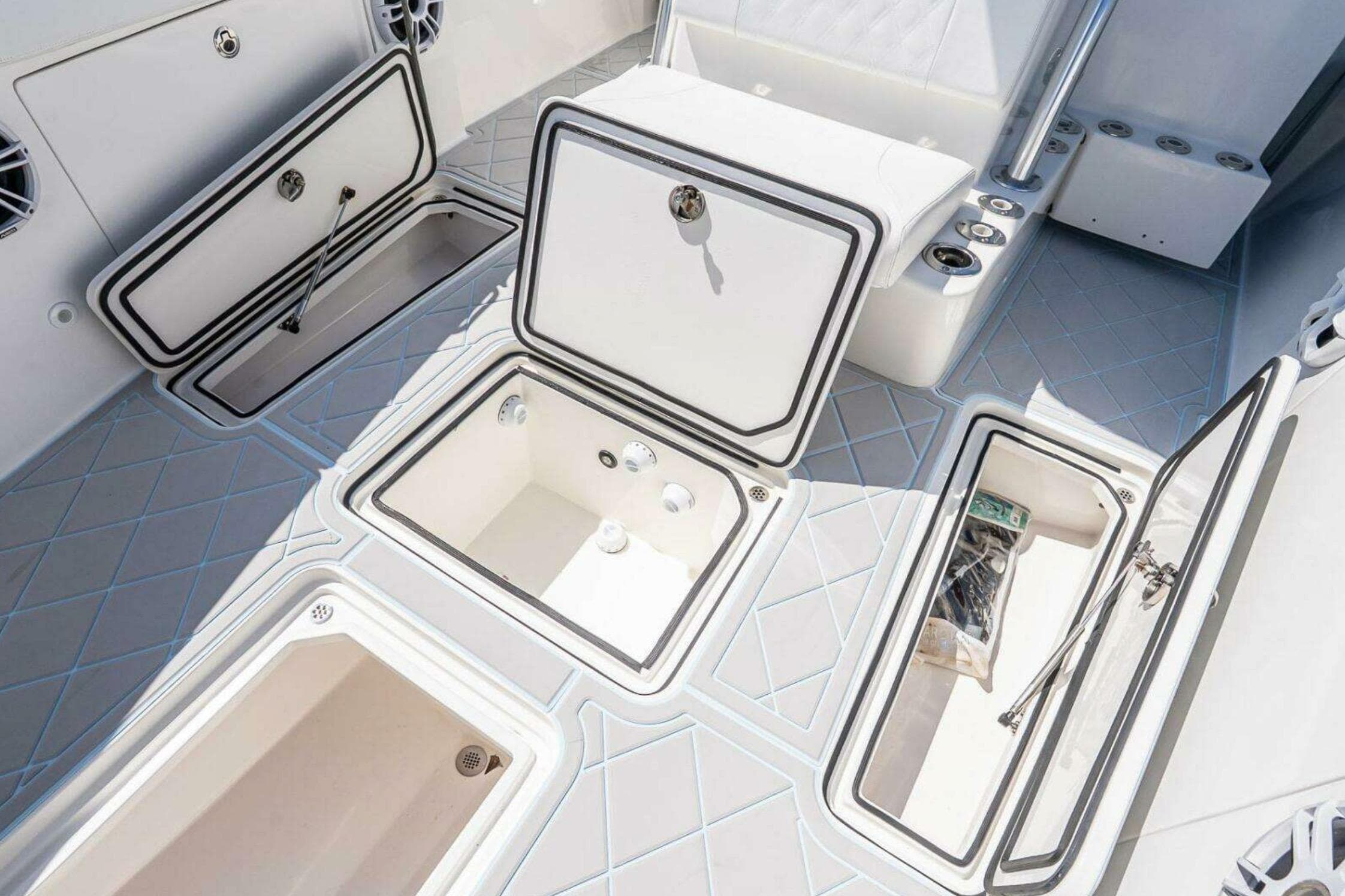 2019 Concept 392 ProFish boat deck with multiple open storage compartments.