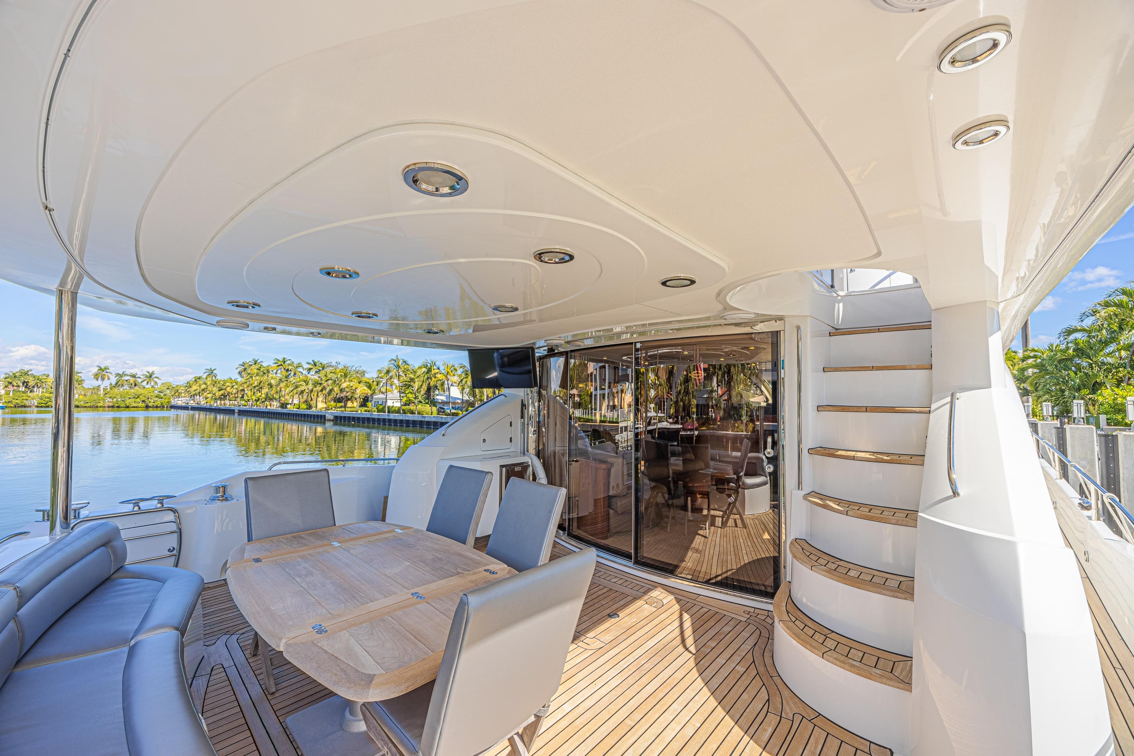 Luxurious 2006 Sunseeker 75 Yacht deck with elegant seating and scenic waterfront view.