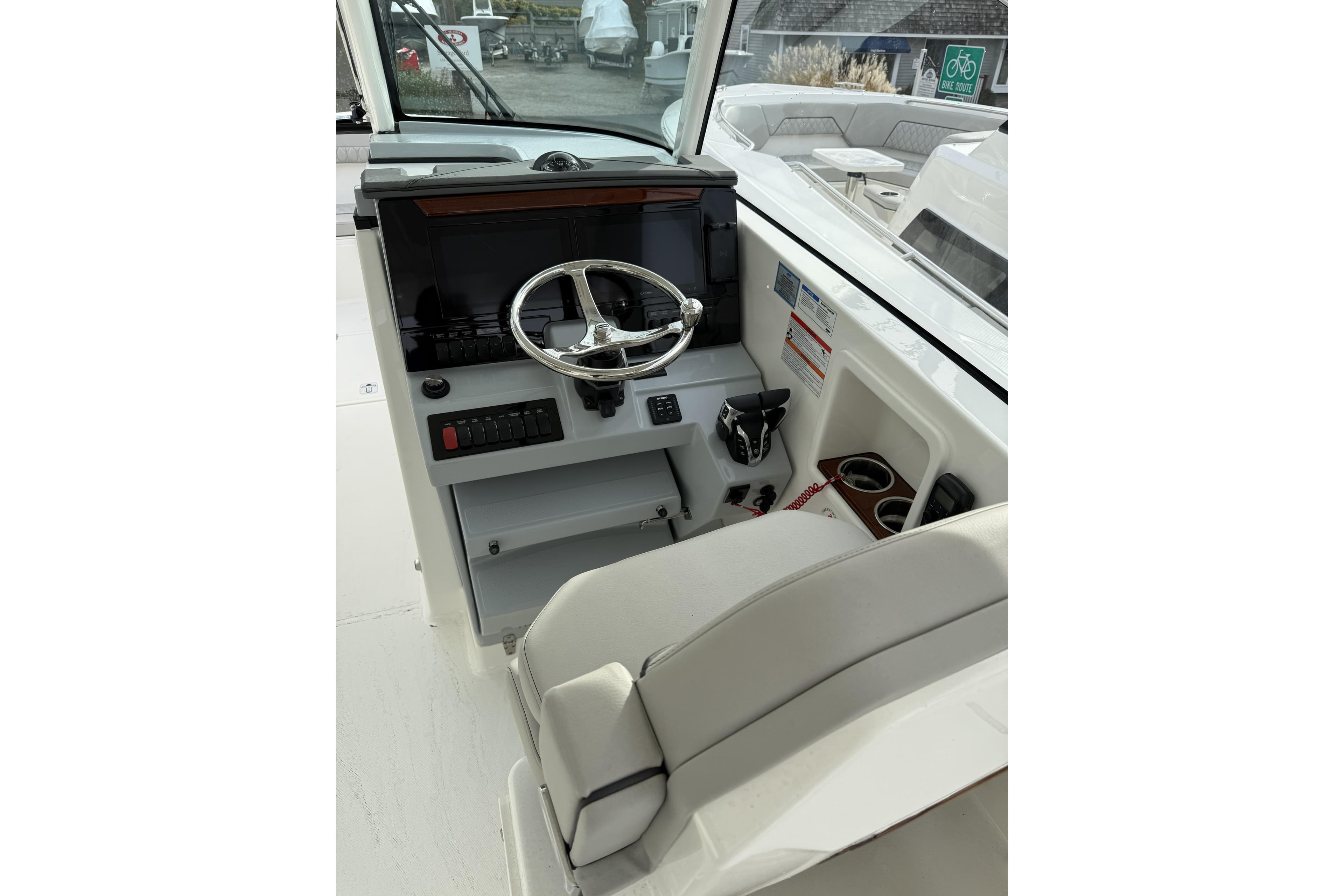 2026 Pursuit DC 306 Dual Console boat helm with steering wheel and controls.