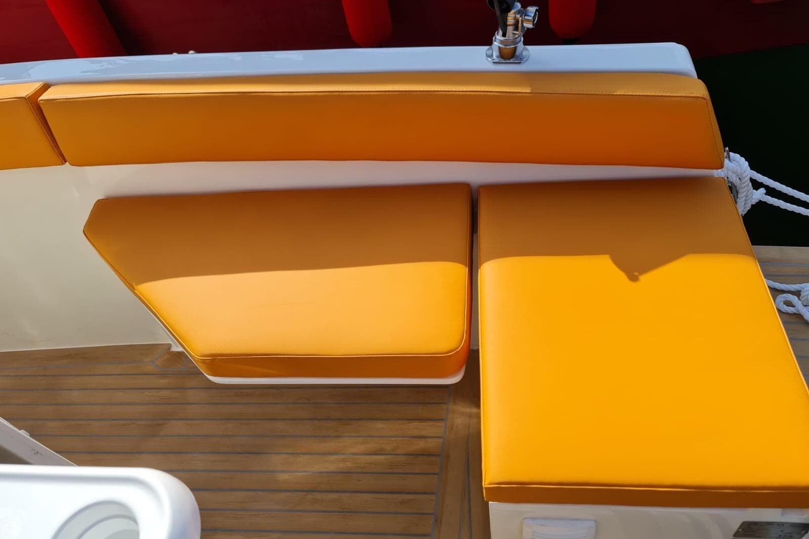 Orange seating on 2025 NUVA YACHTS M6 Fisher, featuring sleek design and wooden flooring.
