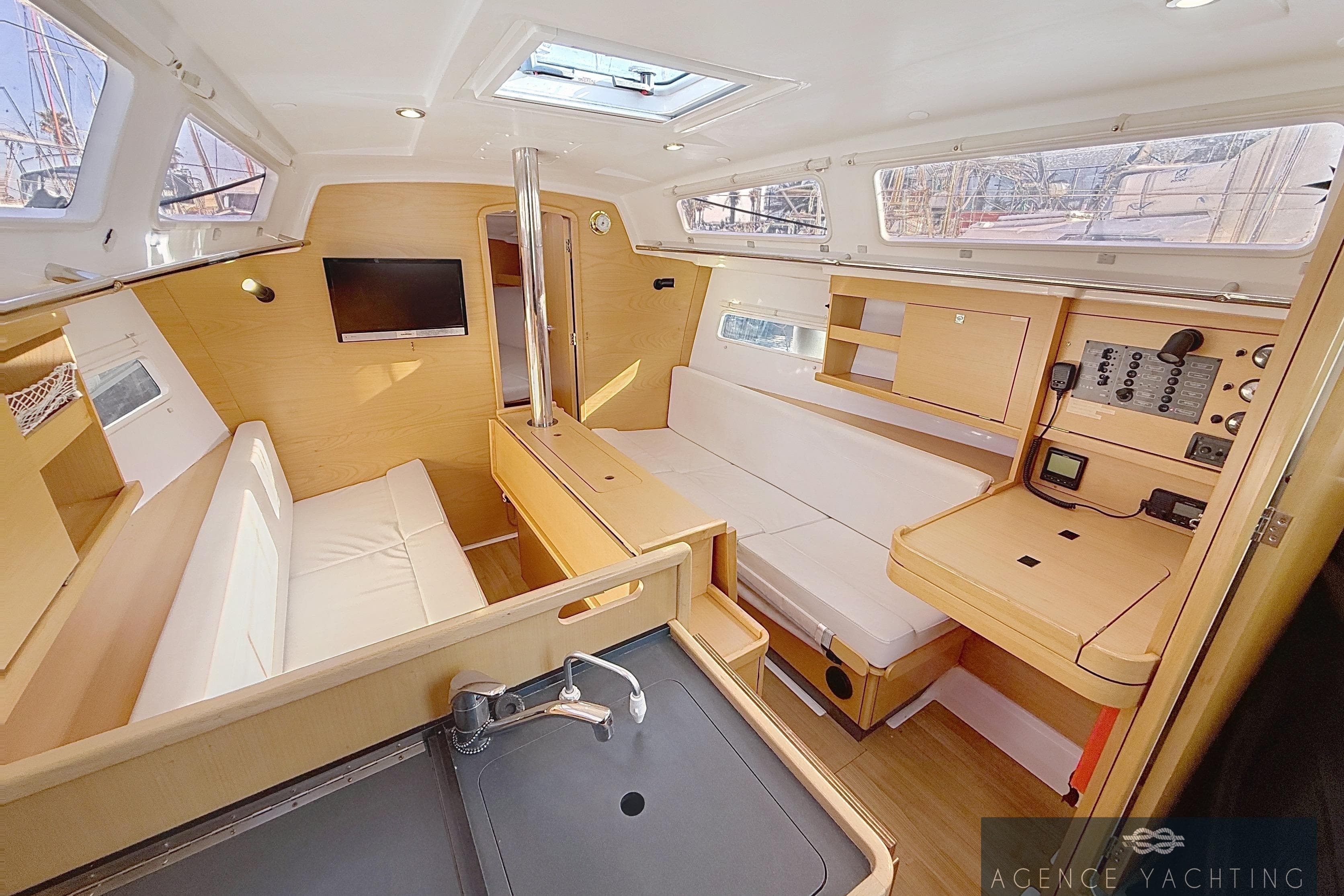 Interior of 2019 Jeanneau Sun Odyssey 319 yacht, featuring modern design and cozy seating.