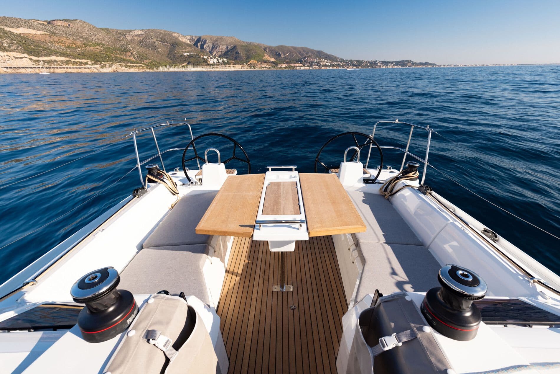 Beneteau Oceanis 34.1 yacht 2026 on open sea with mountain view.