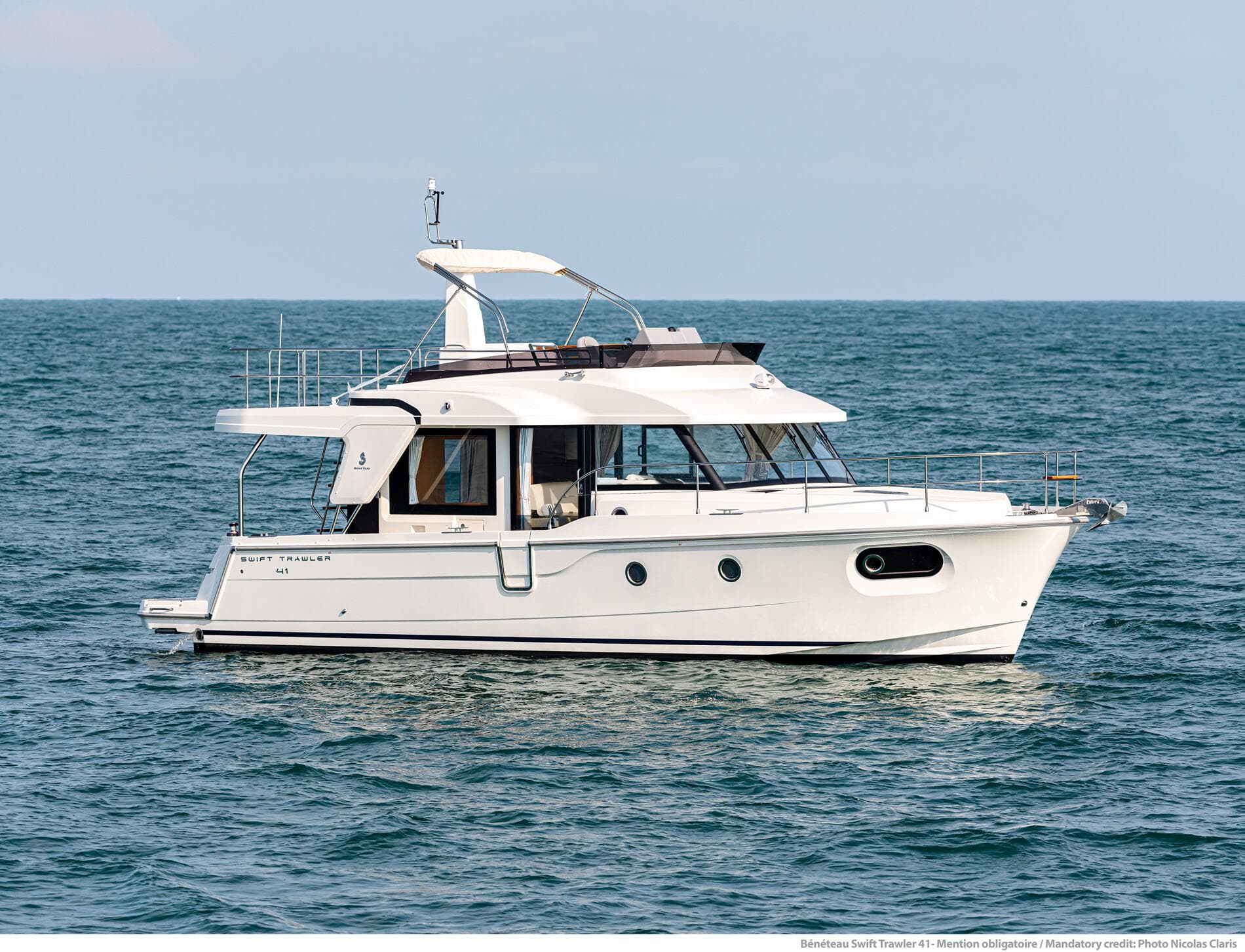2025 Beneteau Swift Trawler 41 Fly cruising on open water.