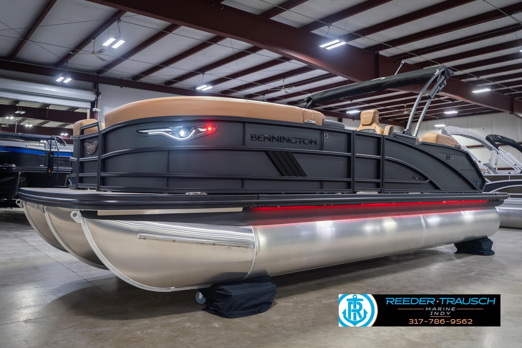 2026 Bennington 22 MSB pontoon boat in showroom with sleek design and modern features.
