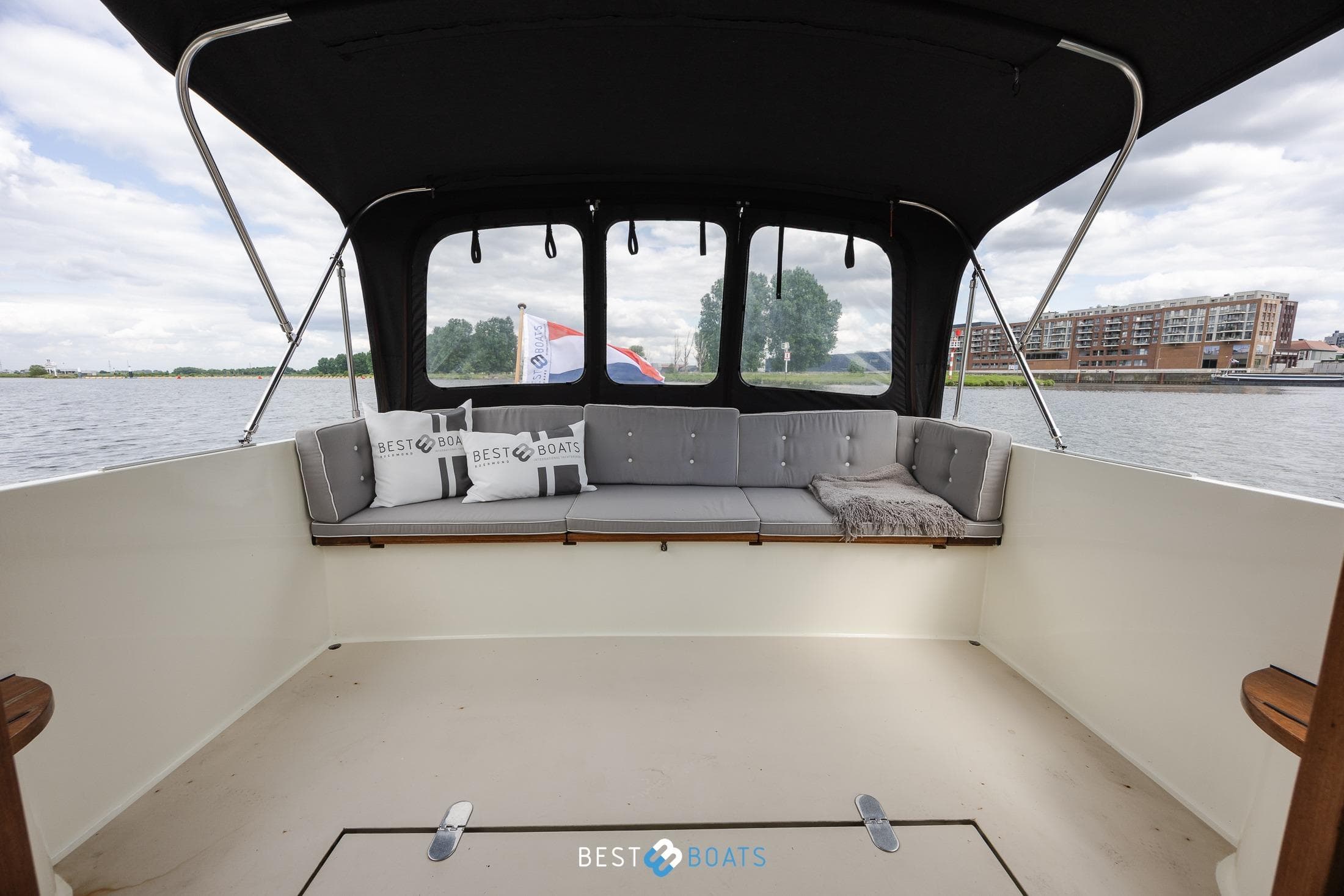 Spacious interior of 2004 Vripack 965 OK boat with comfortable seating and scenic water view.