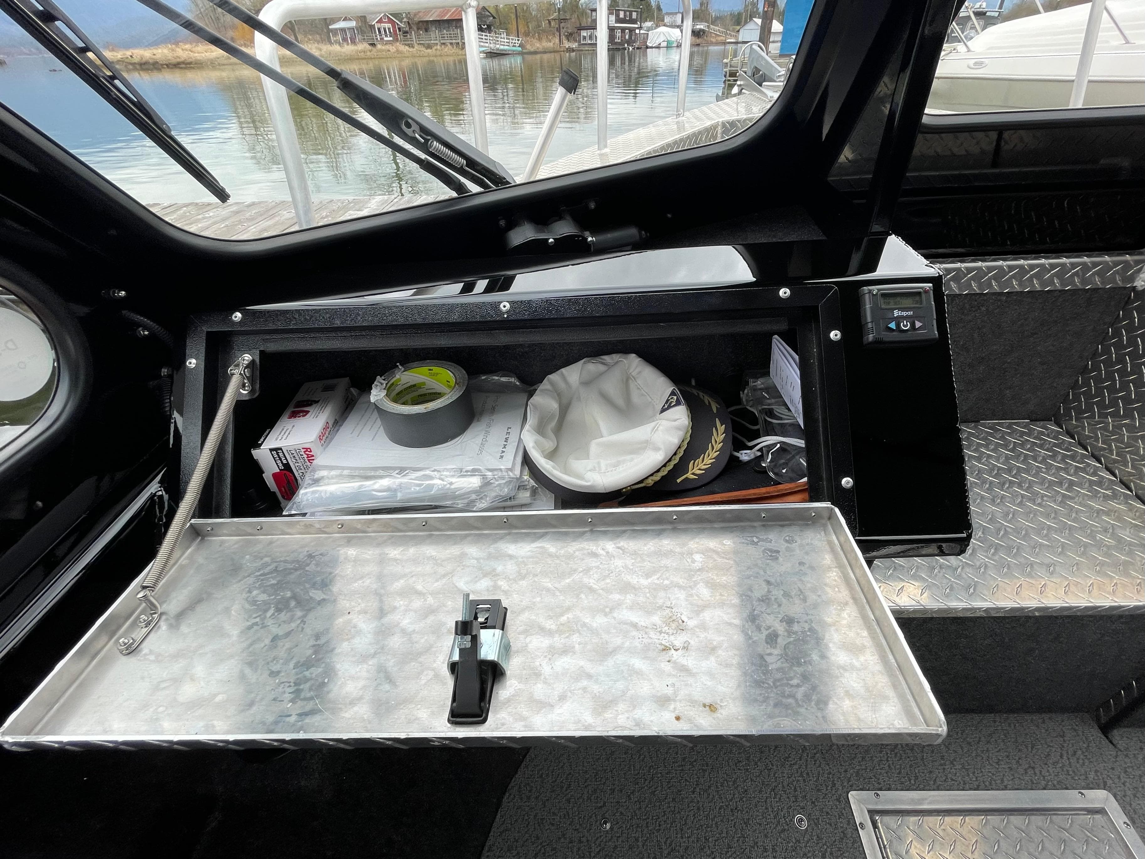 Storage compartment in 2021 Thunder Jet 210 Luxor Limited boat, featuring various boating essentials.