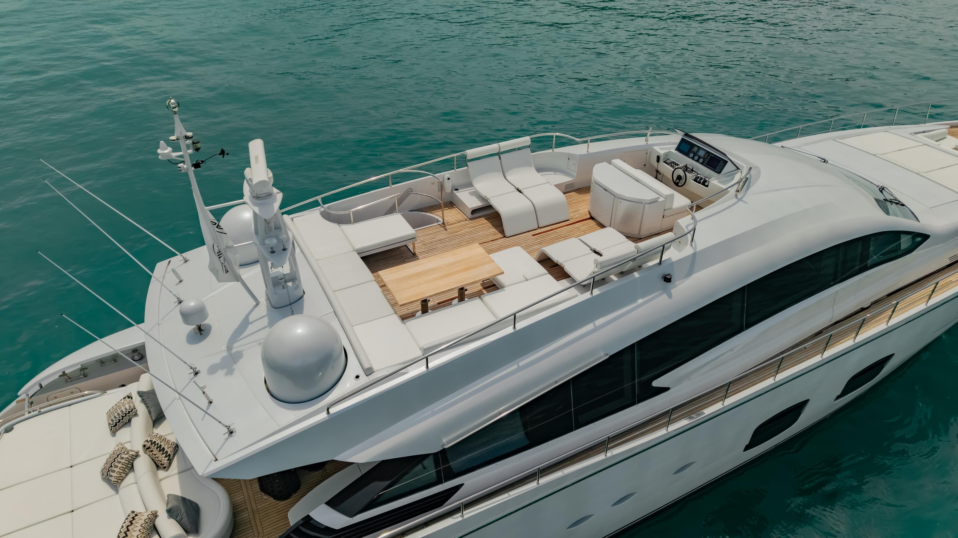Luxury 2011 Pershing 108 yacht on turquoise water, featuring spacious deck and modern design.