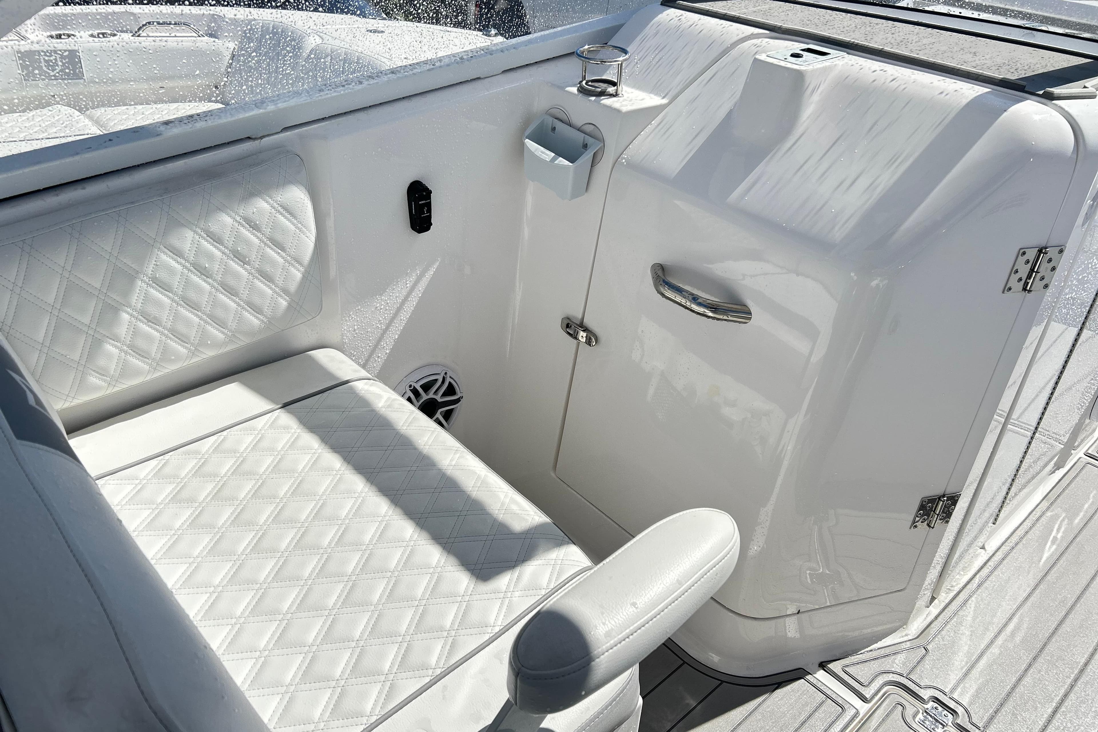 Interior of 2025 Sea Fox 288 Traveler boat with white seating and storage compartment.