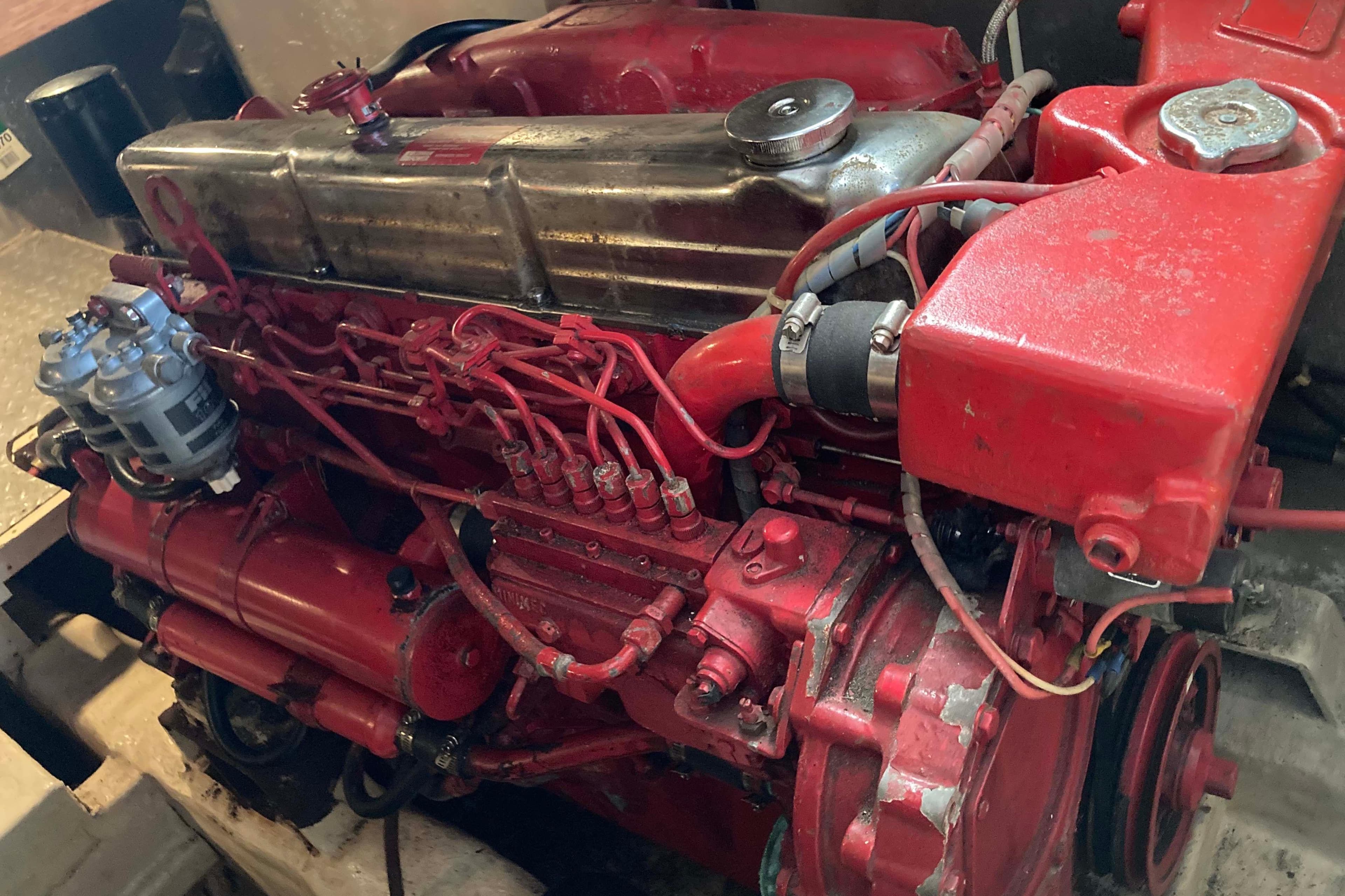 Red engine of a 1988 Albin 43 Trawler, showcasing intricate mechanical components.