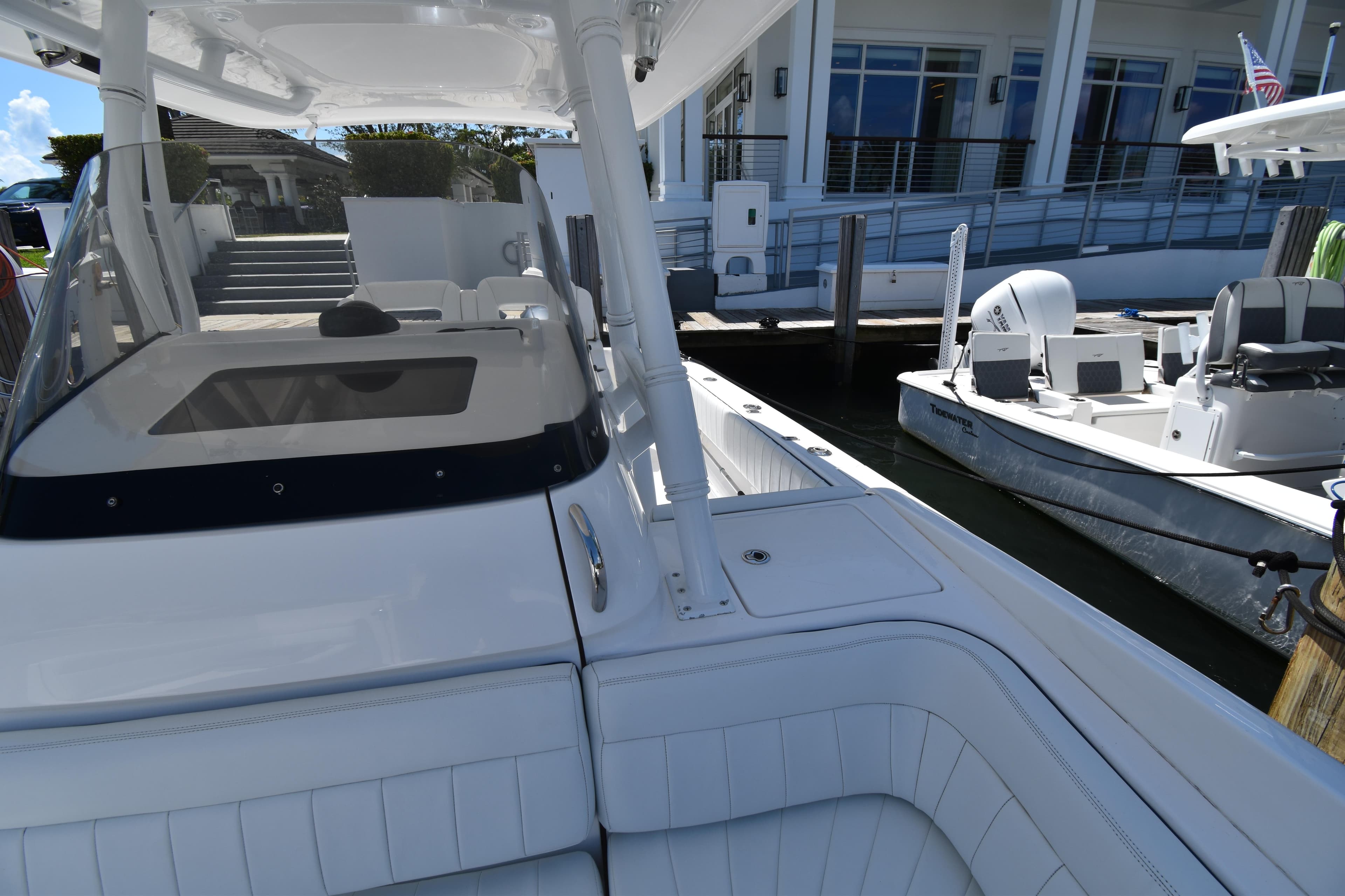 2013 Intrepid 327 Cuddy boat docked at marina with seating area.