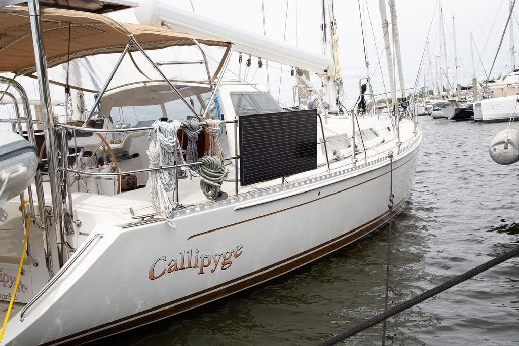 Sailboat "Callipyge" docked, Outbound 46 model, 2015, with solar panel and ropes.
