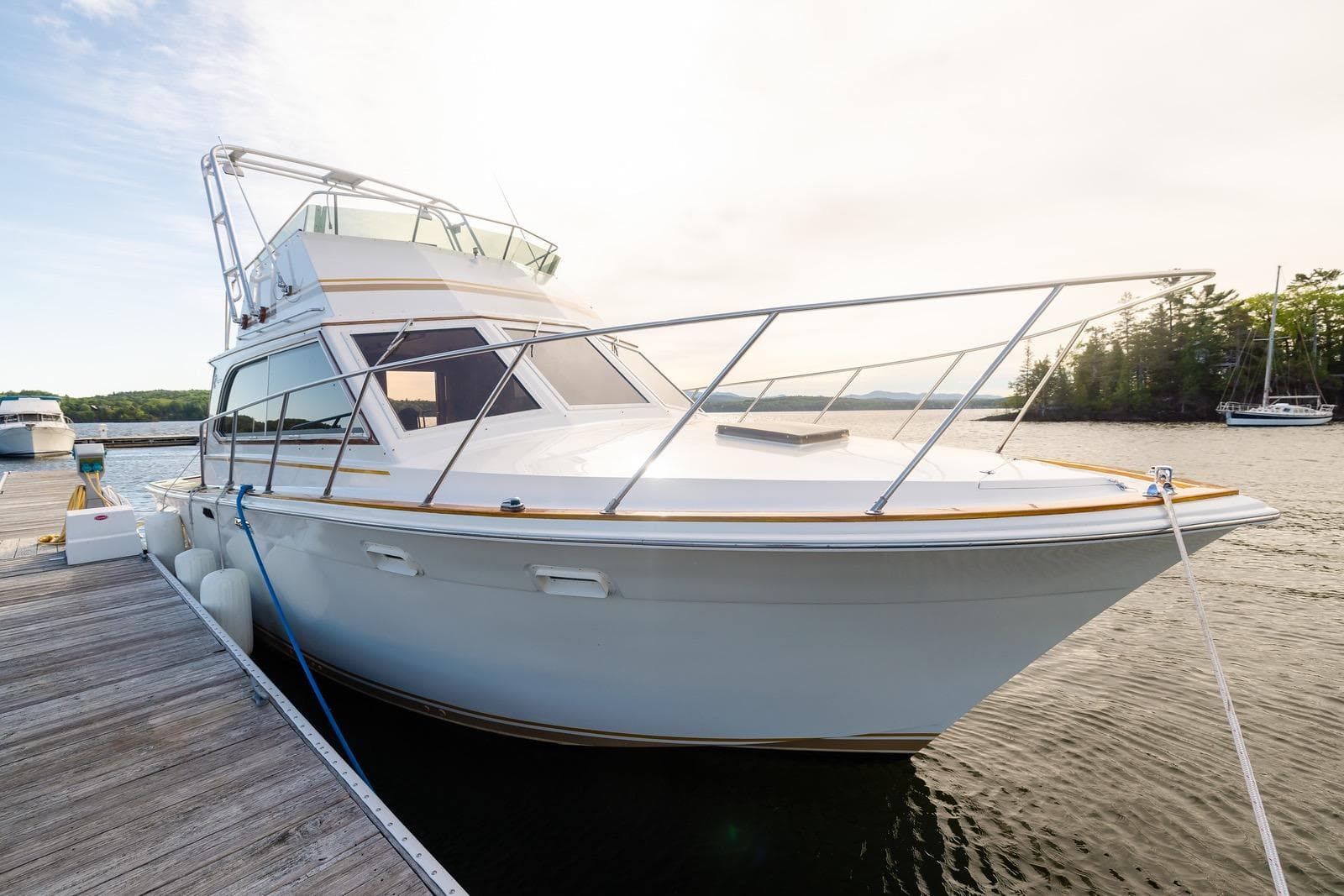 1984 Egg Harbor 33 Convertible yacht docked on a serene lake.