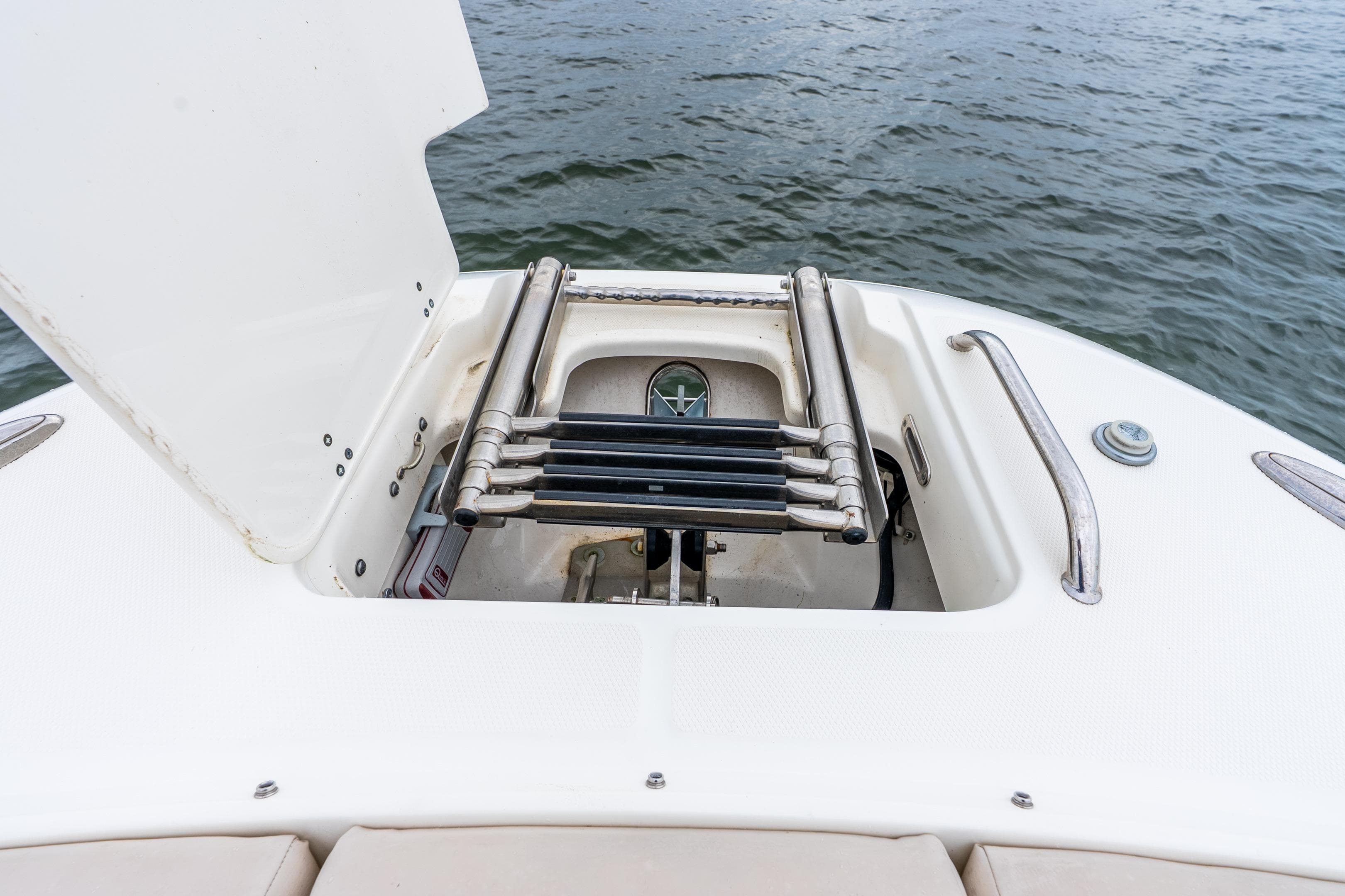 2017 Boston Whaler 320 Vantage swim platform with ladder, open hatch, and ocean view.