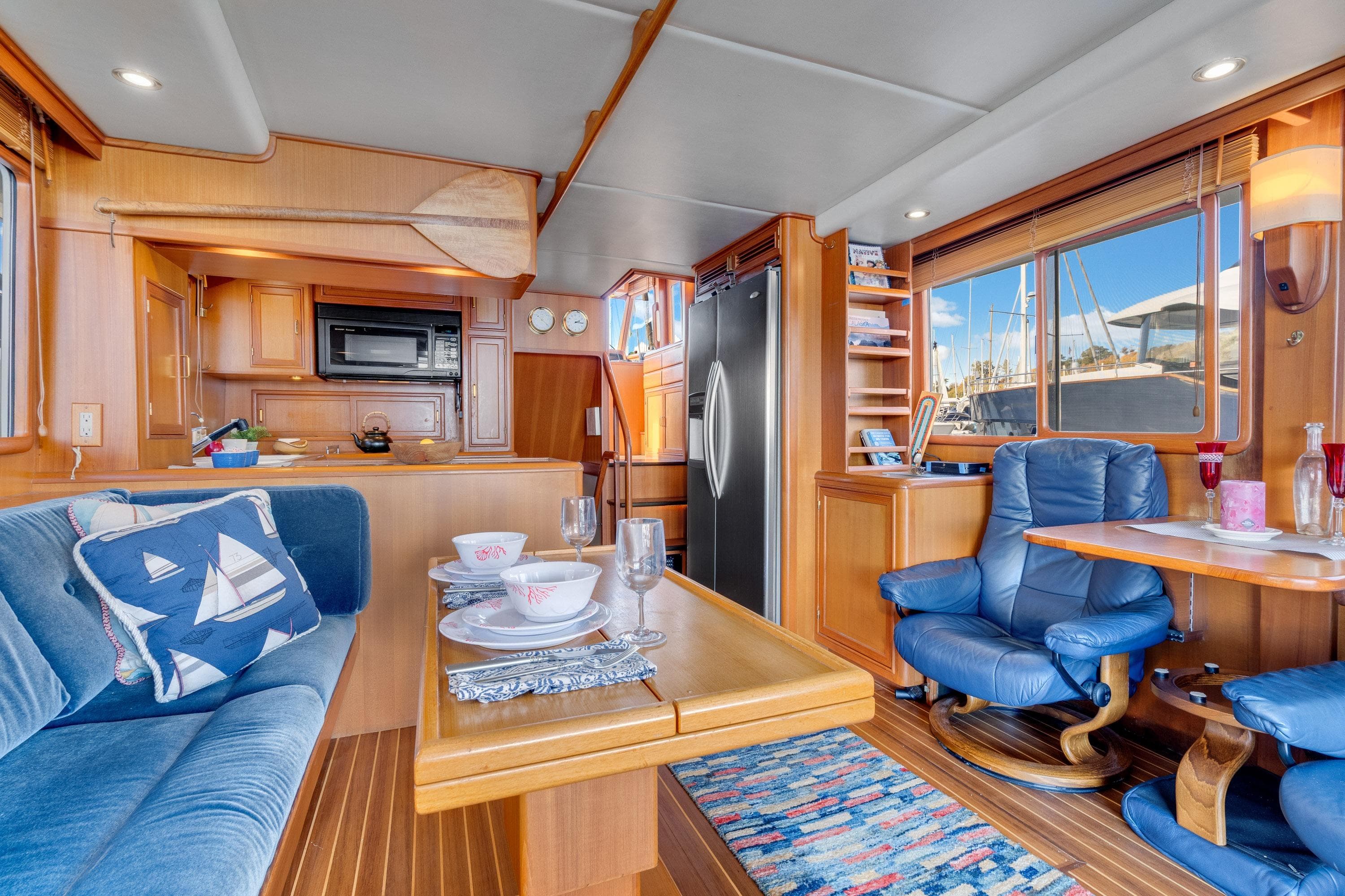 Luxurious interior of 2001 Fleming 55 Pilothouse yacht with dining and seating area.