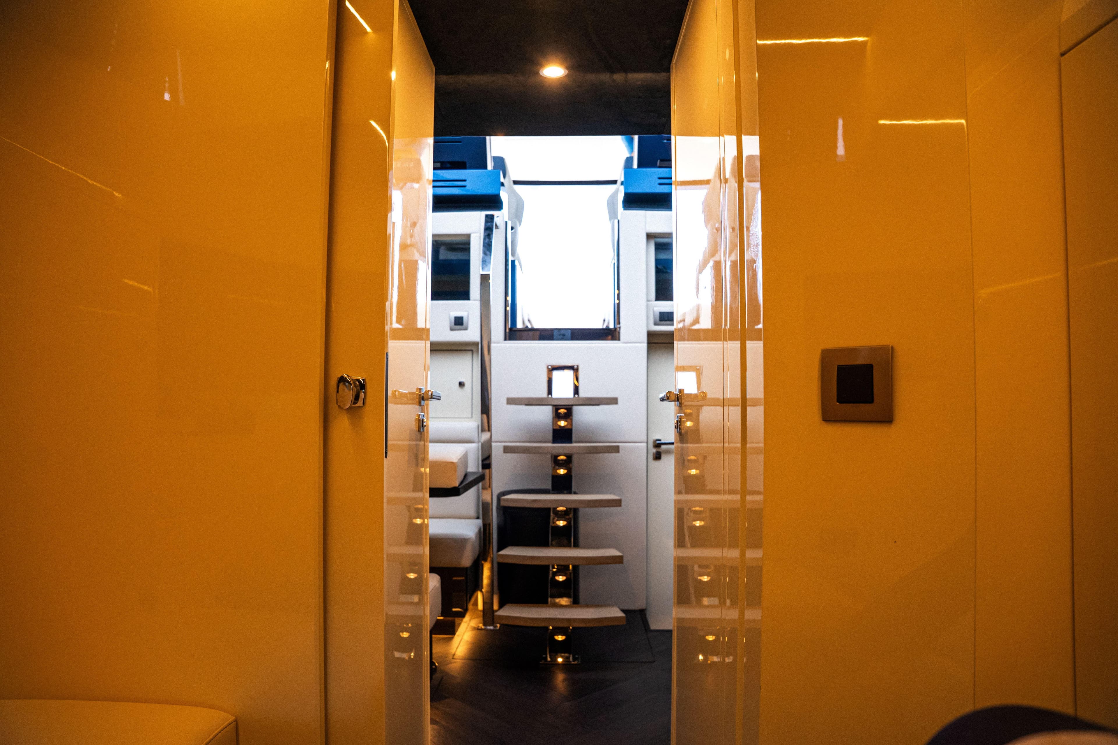 Luxurious interior of 2025 Dutch American DA 53 yacht with modern staircase and lighting.