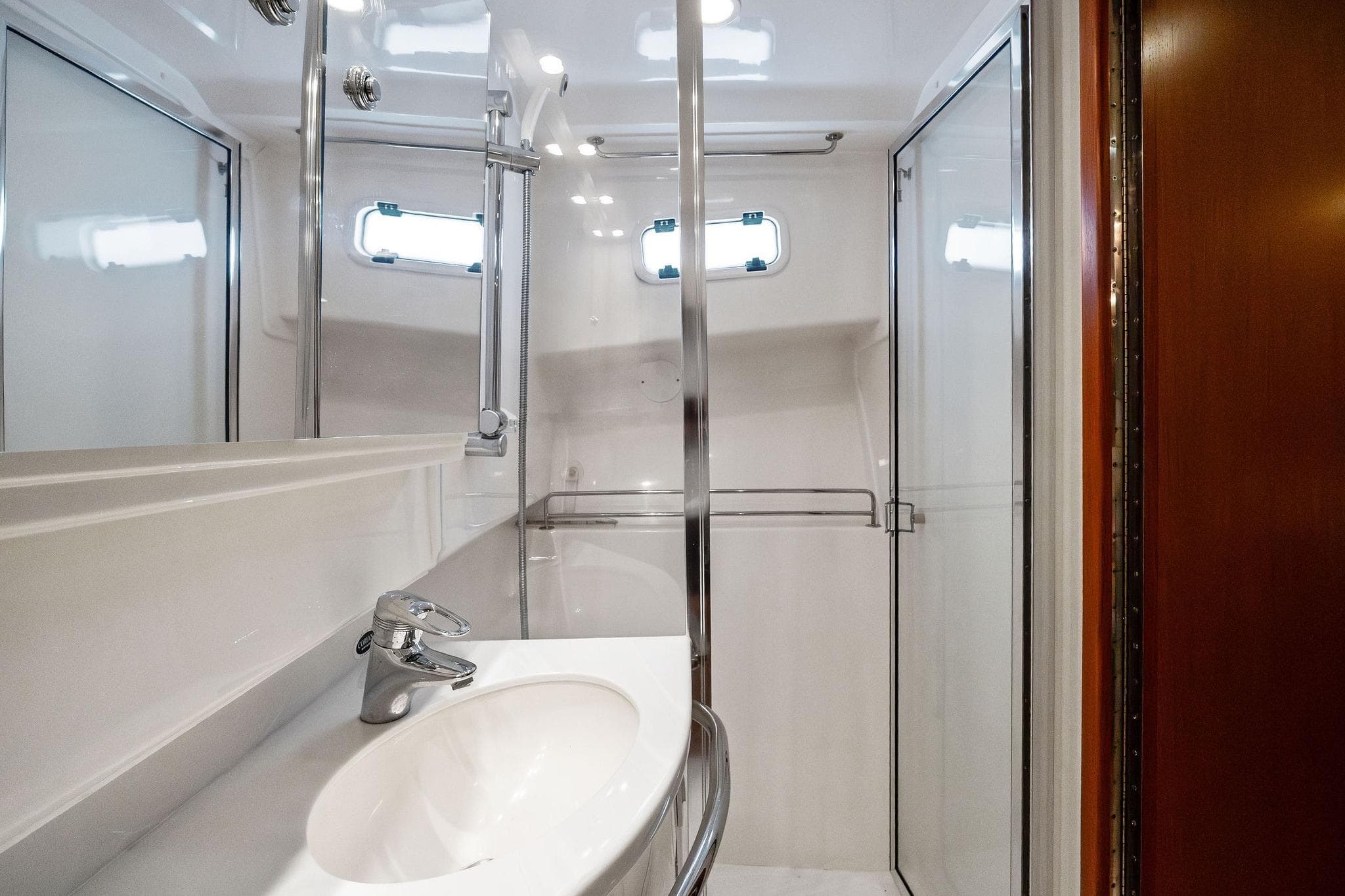Luxurious bathroom in 2004 Cabo 40 Hardtop Express yacht with modern fixtures and shower.