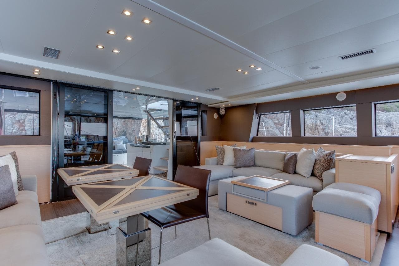 Luxurious interior of 2017 Lagoon 620 Essence yacht with modern seating and dining area.