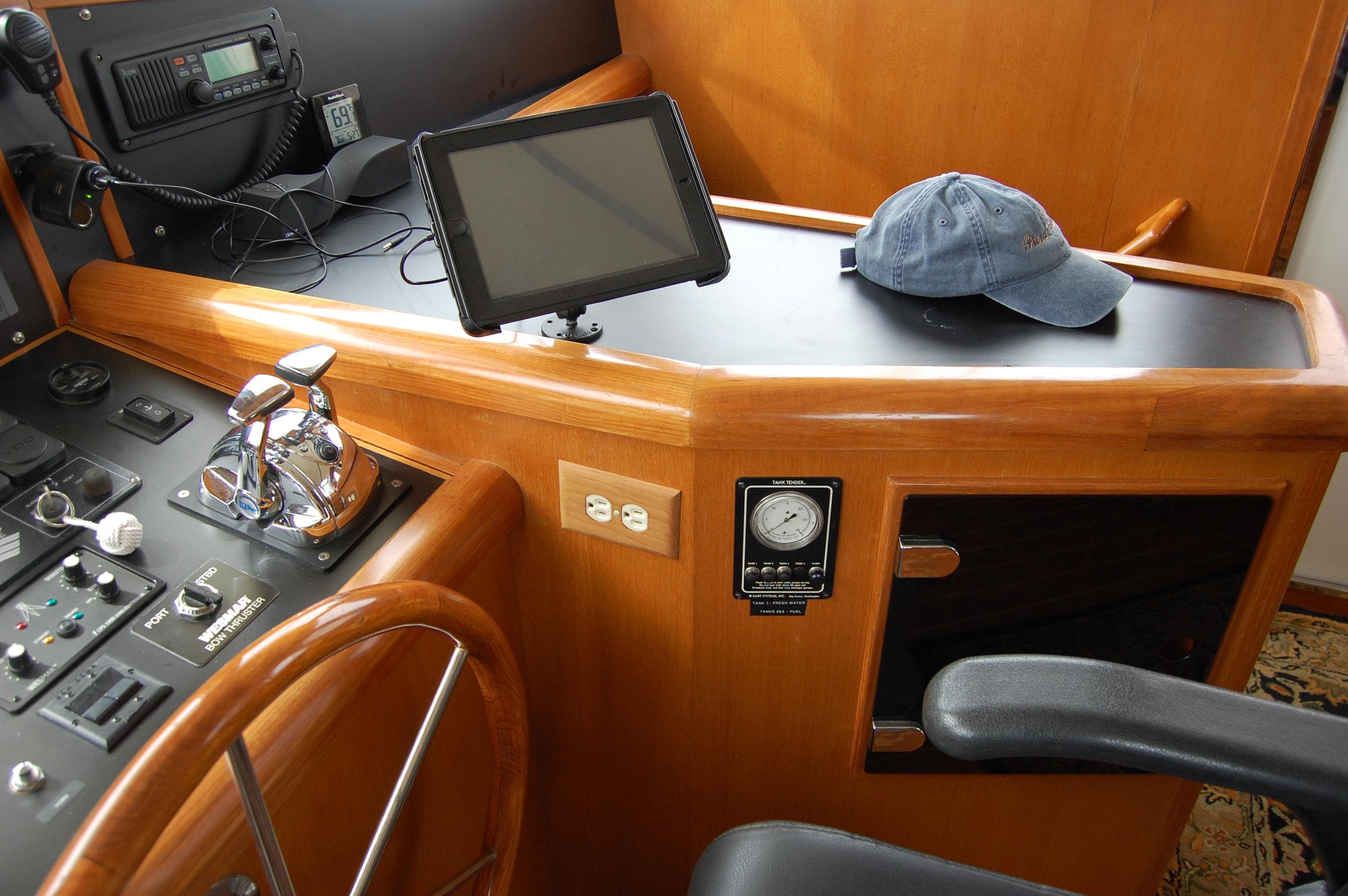 2002 Eagle Pilothouse helm with steering wheel, controls, and navigation equipment.