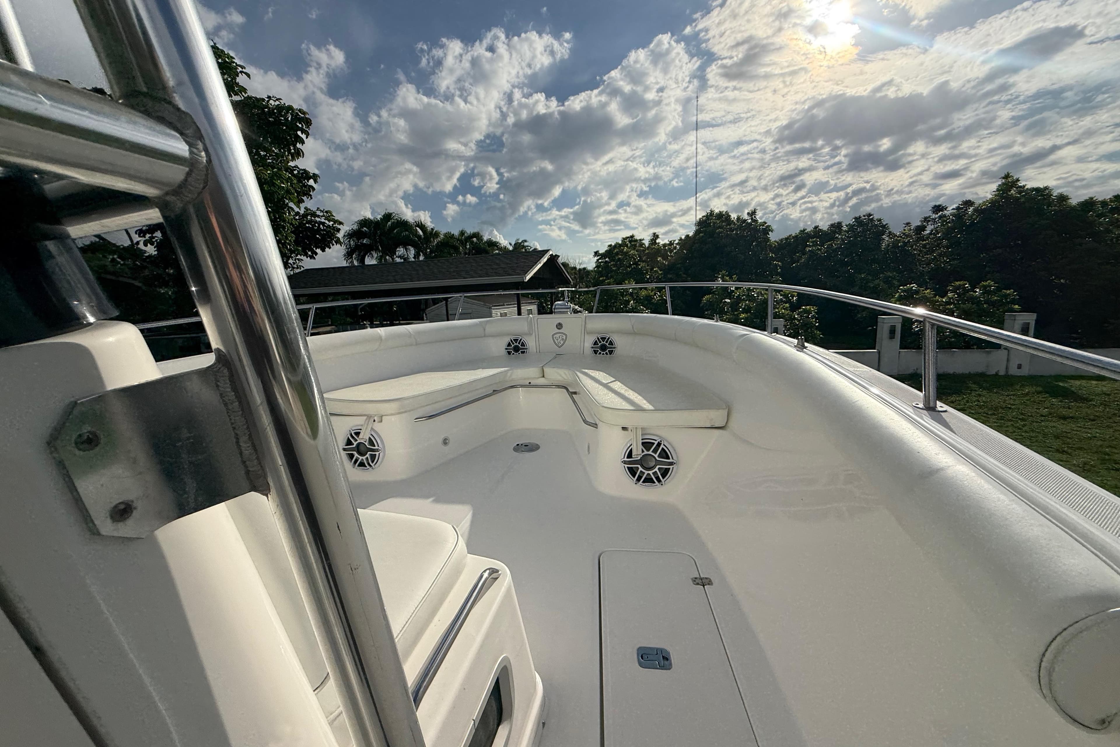 2007 Century 3200 Center Console boat deck under a partly cloudy sky.