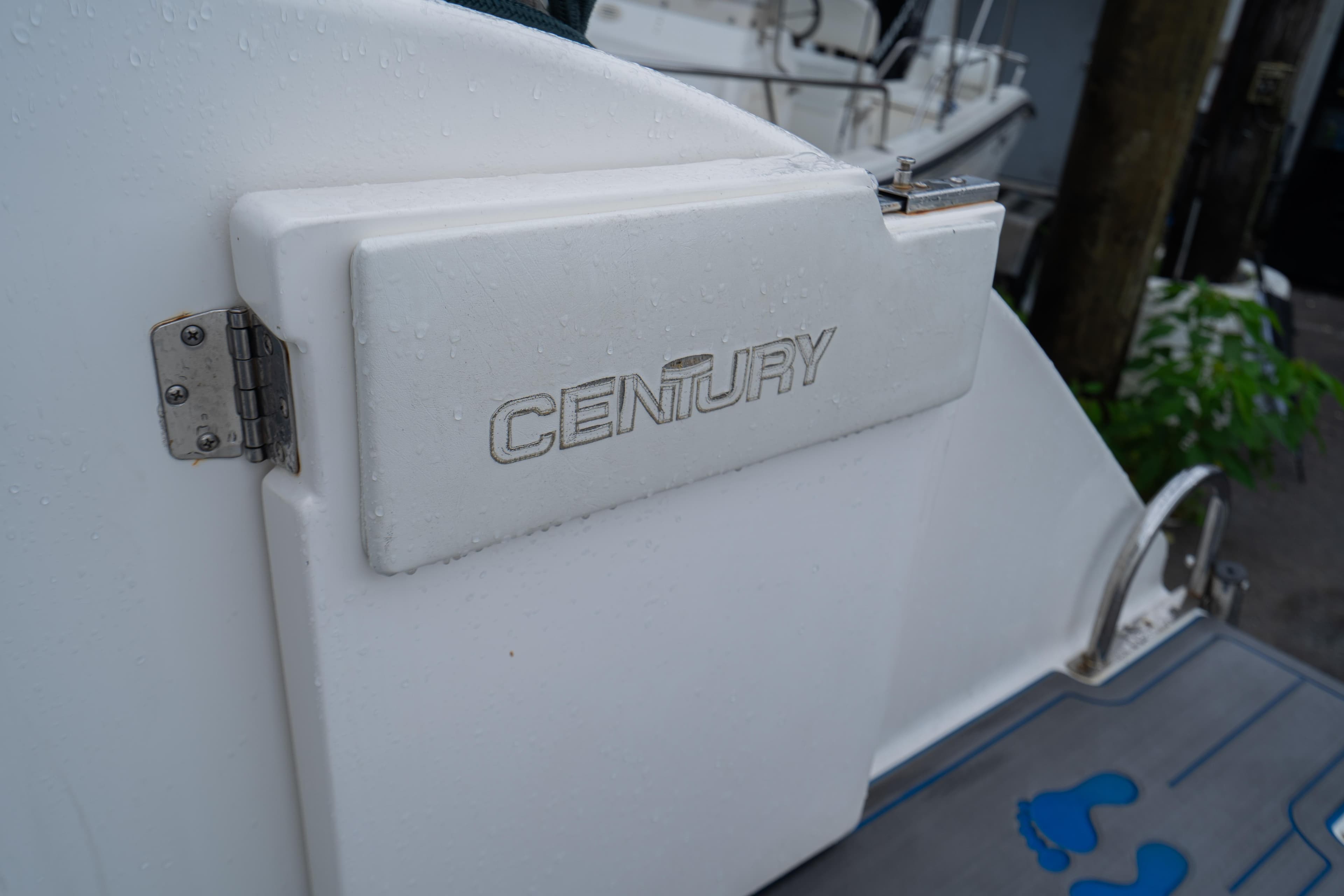 Century 3200 Walk-Around boat, 2002 model, featuring a white exterior with logo detail.