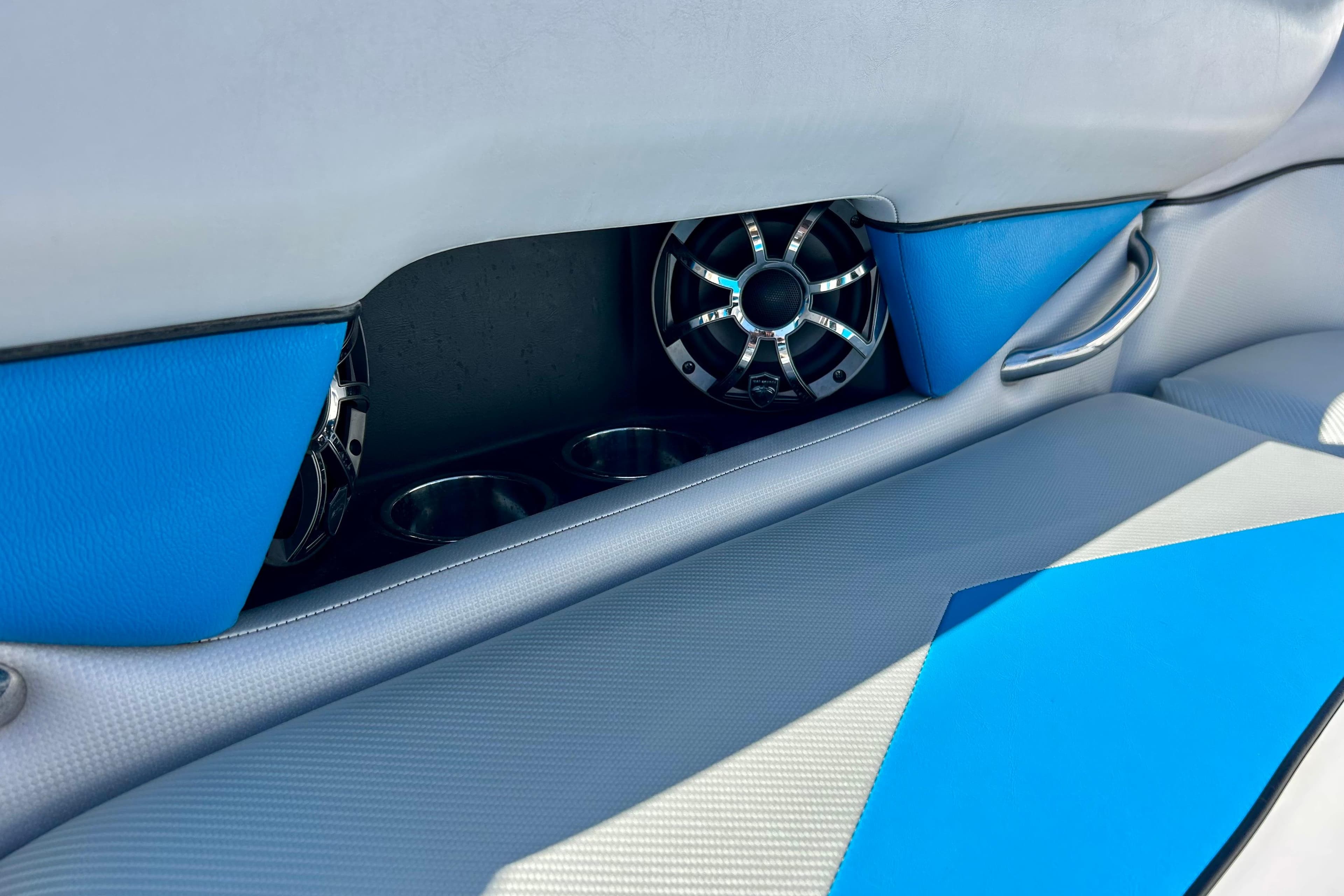 2012 Moomba Mojo 2.5 interior with blue accents, speakers, and cup holders.