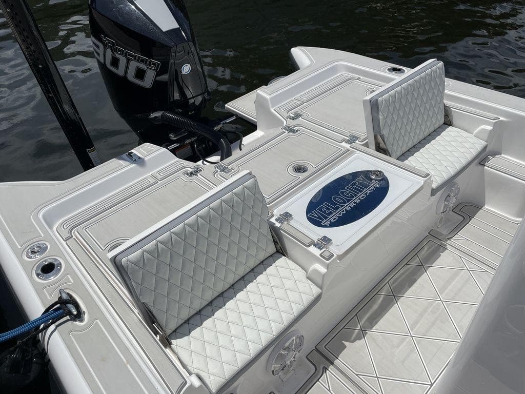 2023 Velocity 260 Bay boat with cushioned seating and powerful outboard motor.